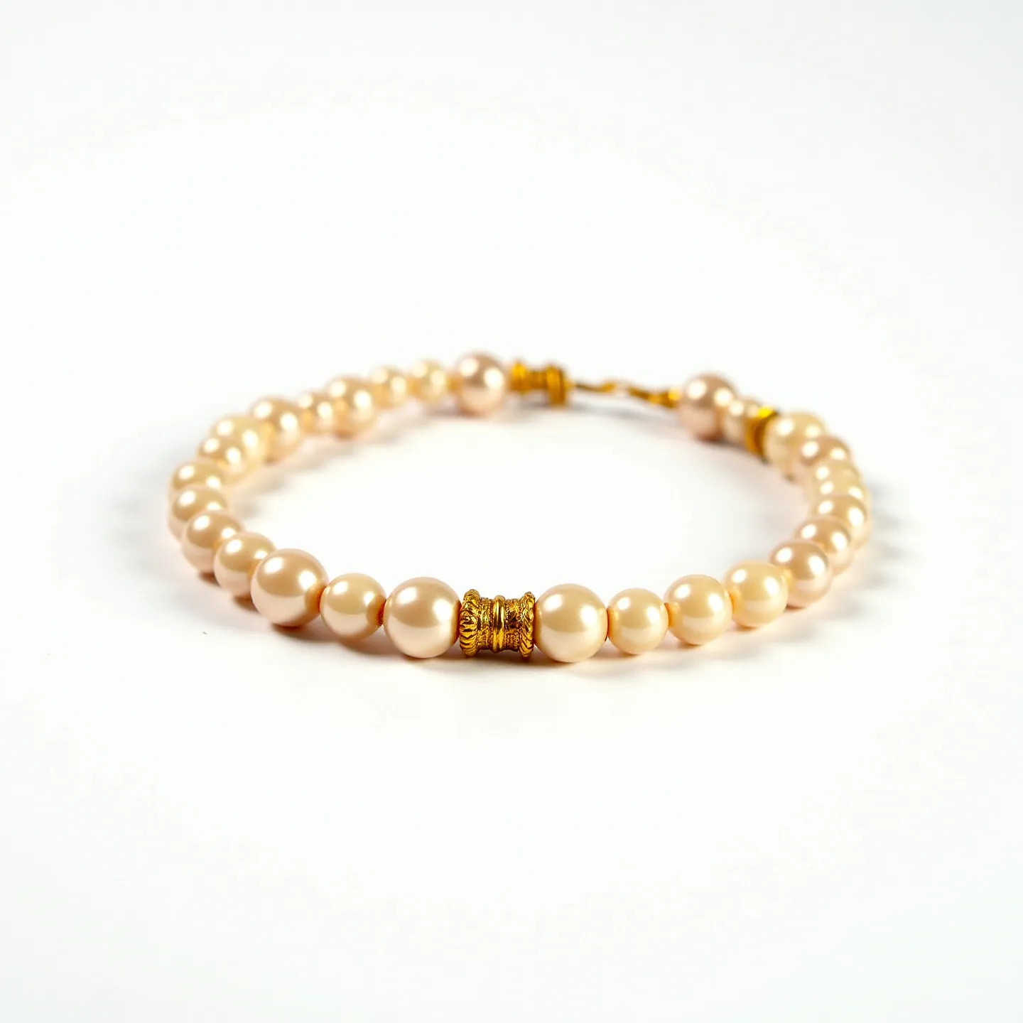 This baby bracelet features a delicate and classic design with a series of small, round pearls strung together. The pearls possess a soft, creamy luster indicative of their high-quality. The bracelet is accented with intricately crafted golden spacers that add an element of elegance and sophistication. The closure is a gold-toned clasp, which ensures secure and comfortable wear. Overall, the combination of the pearls and the gold accents makes this baby bracelet a charming piece of jewelry.