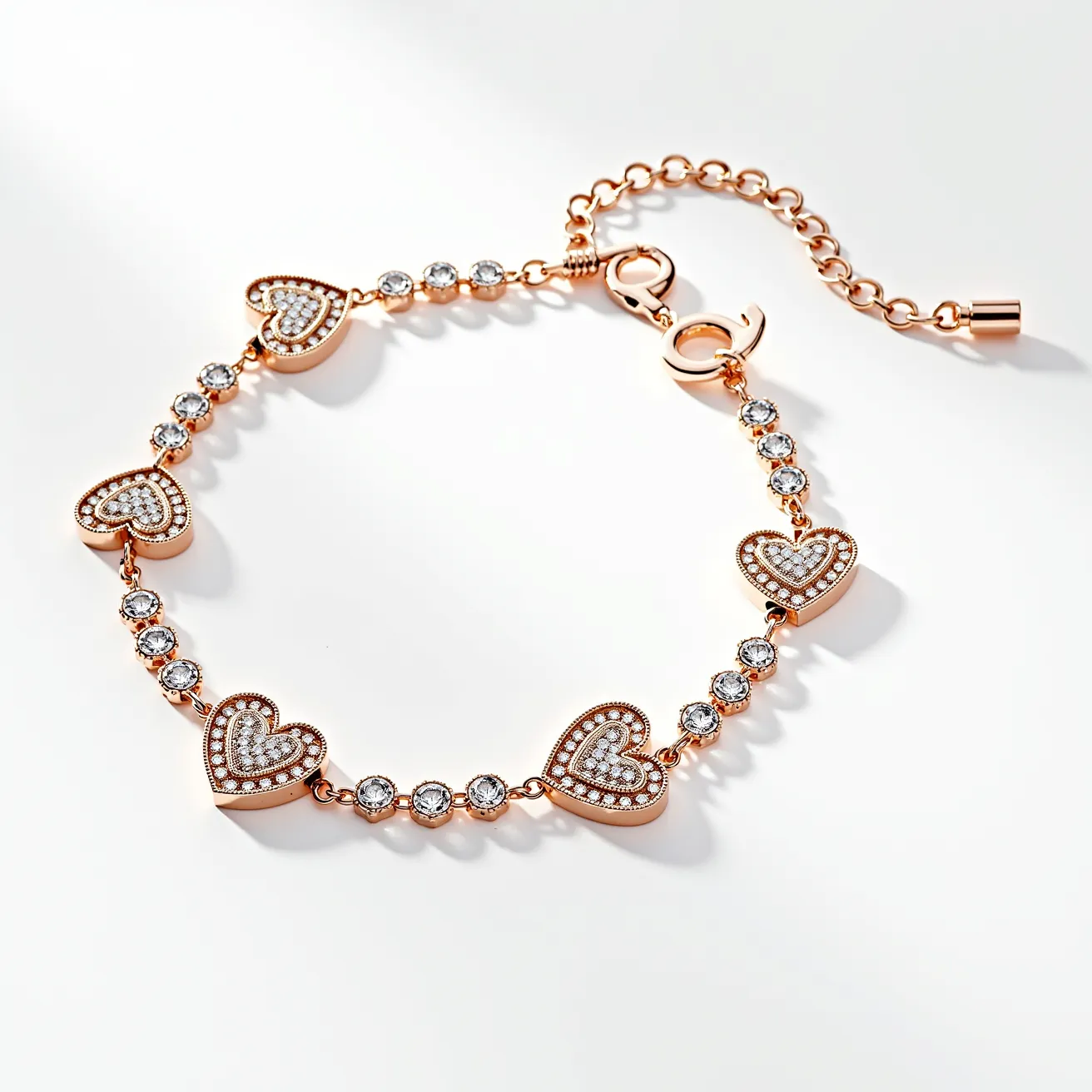 This charm bracelet features a series of heart-shaped charms and round, faceted gems. The hearts are made from a rose gold-toned metal and are adorned with small, clear stones set in a pavé setting. Each heart charm is connected by a pair of prong-set, round-cut, clear gems, totaling five heart charms and ten round gems distributed along the bracelet. The bracelet is fitted with an adjustable chain and a lobster clasp, also in a matching rose gold tone, ensuring secure and flexible wear.