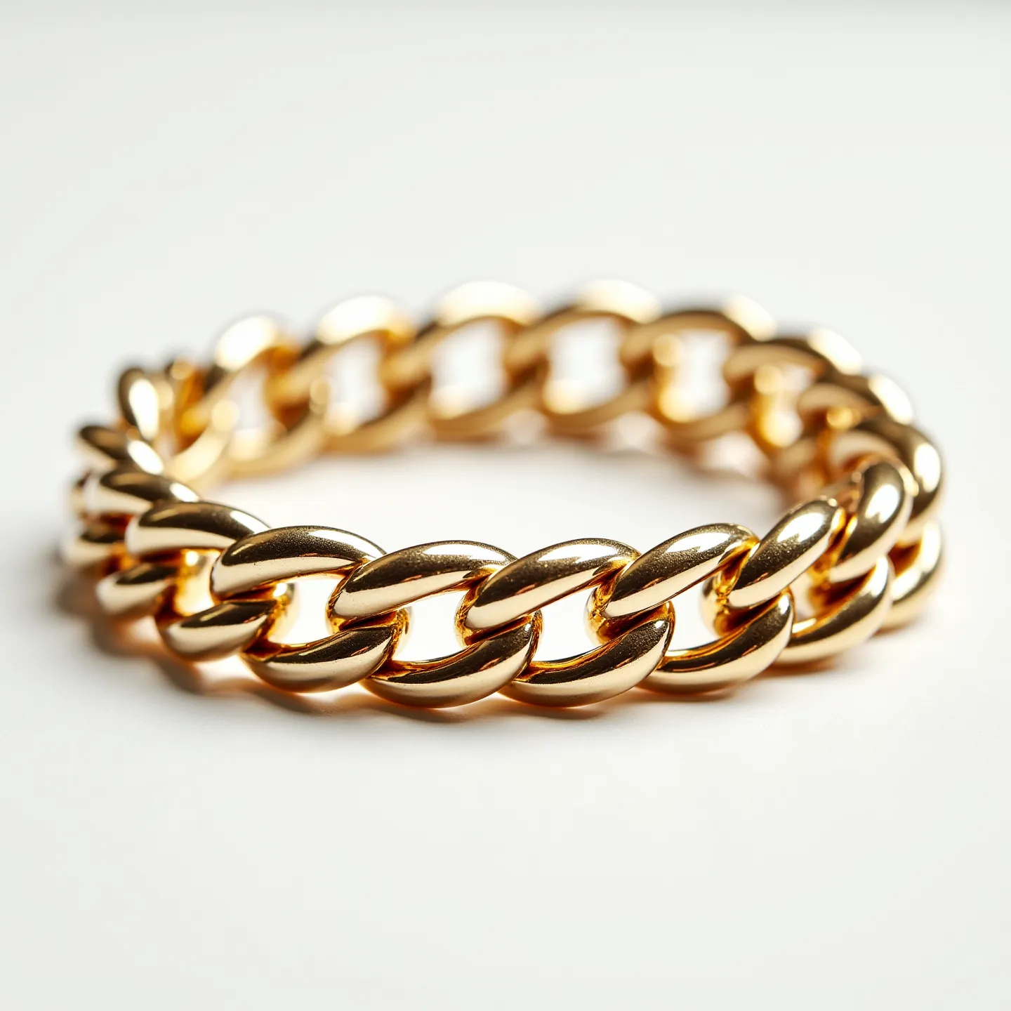 This cuban link bracelet is fashioned from a lustrous golden material, featuring substantial, interlocking links that give it a bold and sturdy appearance. The links are polished to a high sheen, enhancing the overall luxurious and elegant aesthetic of the piece. There are no visible gems or stones set into the bracelet. The clasp is designed to blend seamlessly with the links, maintaining the continuous and cohesive look characteristic of Cuban link jewelry.