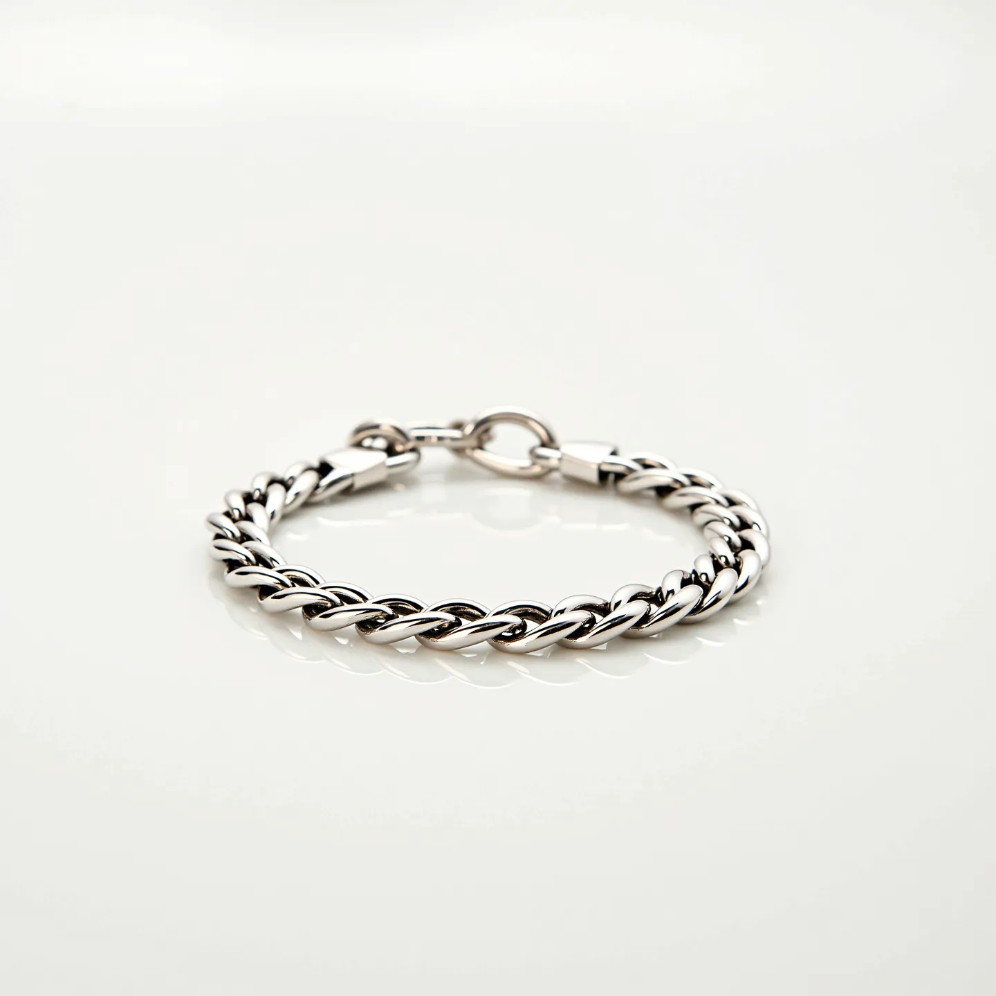 This cuban link bracelet features a sleek design with interlocking links composed of a polished metallic material, most likely stainless steel or sterling silver. The links exhibit a smooth and reflective surface, enhancing the bracelet's elegant appearance. It is equipped with a secure clasp mechanism that seamlessly integrates with the overall design, ensuring both functionality and aesthetic appeal. The sturdy construction of the bracelet suggests durability and the ability to withstand everyday wear, making it a versatile accessory.