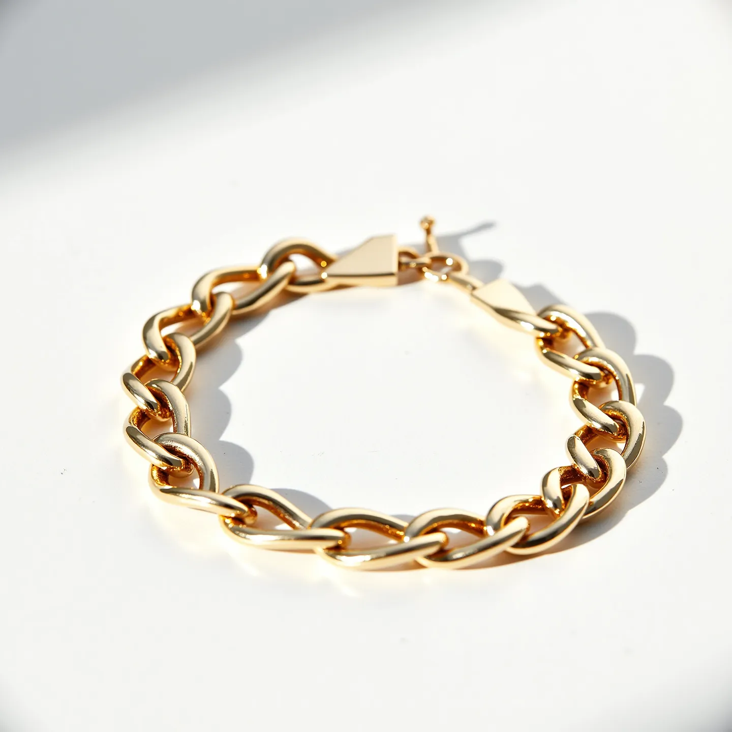 This Cuban link bracelet features tightly interlocked links crafted from what appears to be high-polish yellow gold, giving it a luxurious and sophisticated look. The bracelet is secured with a box clasp, which provides both a secure fastening and a seamless appearance when closed. The links are substantial and exhibit a smooth, rounded edge, enhancing the bracelet's robust and elegant design. Overall, the simplicity and quality of materials in this Cuban link bracelet underscore its classic and timeless style.