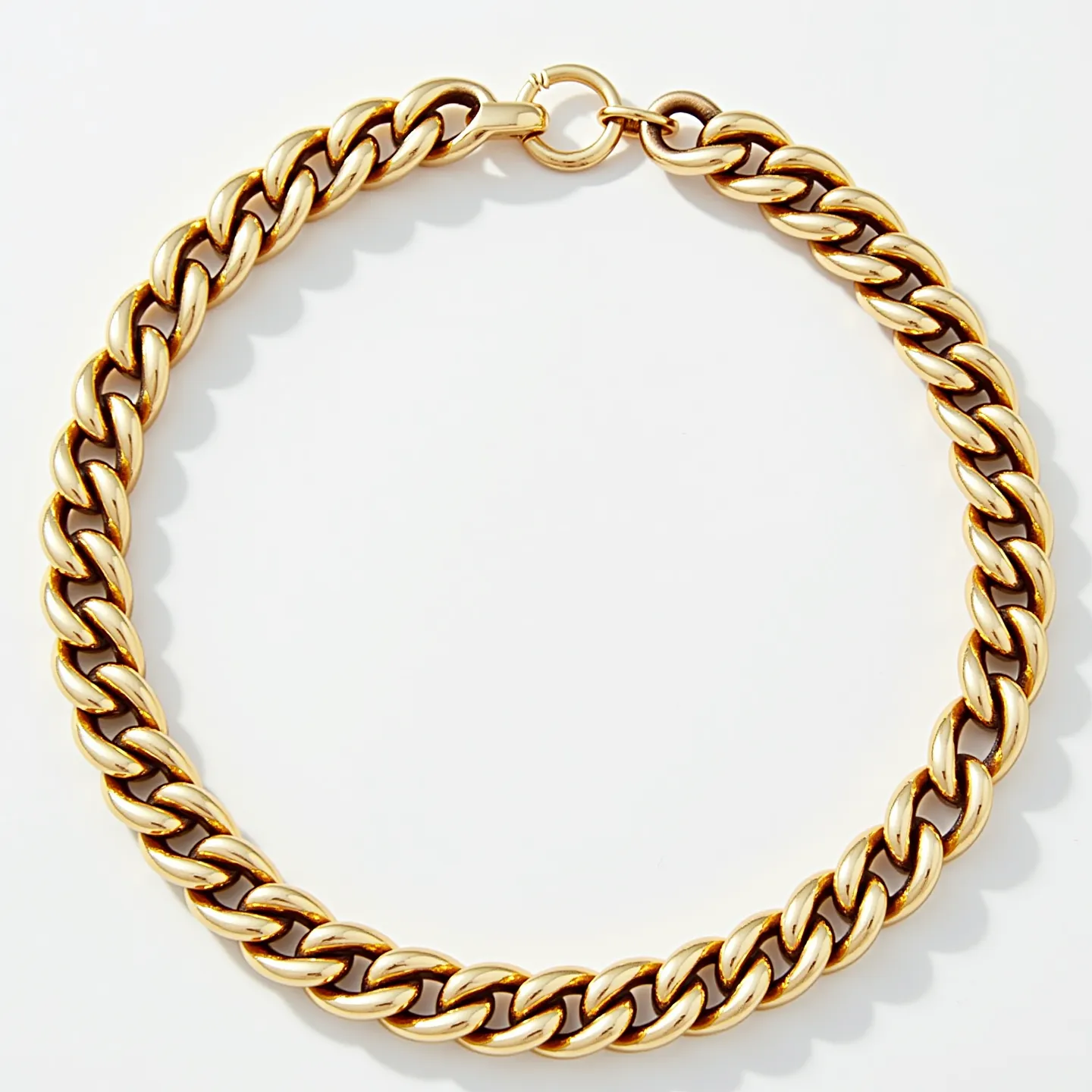 This cuban link bracelet features interlocking oval links crafted from what appears to be polished yellow gold, lending it a luxurious and classic look. The bracelet is devoid of any gemstones or additional adornments, focusing instead on the inherent elegance of its linked design. It is secured with a round spring ring clasp, providing both ease of use and a secure closure. The quality and uniformity of the links exhibit fine craftsmanship, making it a sophisticated accessory for any occasion.