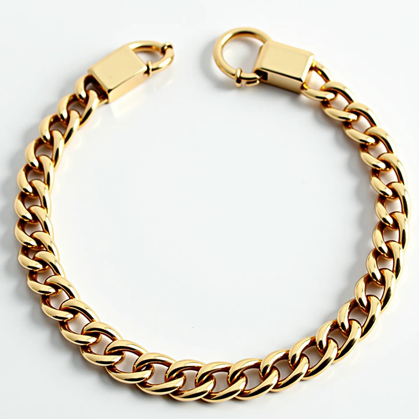 This cuban link bracelet features interlocking, flat, oval-shaped links that create a sleek and polished appearance. It is made of a gold-colored material, giving it a luxurious and shiny finish. The bracelet is secured with a sturdy, box clasp that includes a circular latch for added security. There are no visible gems or stones embedded in the design, emphasizing the elegant simplicity of the piece.