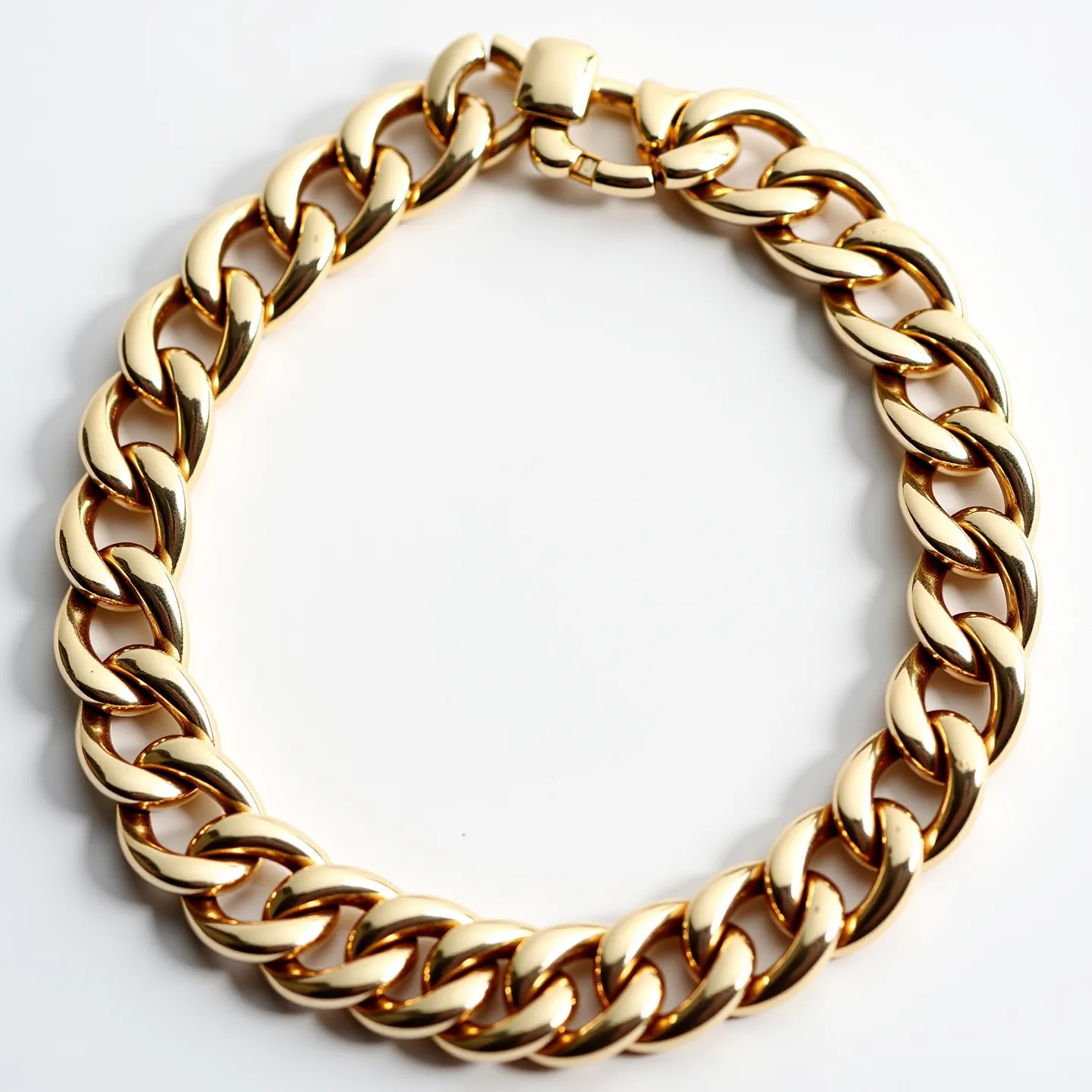 This Cuban link bracelet features a series of interlocking, rounded, and polished links, creating a substantial and cohesive chain design. Made from what appears to be gold or a high-polish gold-plated metal, each link seamlessly connects to the next, providing a smooth and continuous form. The bracelet is secured with a box clasp, ensuring both security and a sleek, uninterrupted appearance. The overall craftsmanship highlights the classic and durable nature of the Cuban link style, ideal for both casual and formal wear.