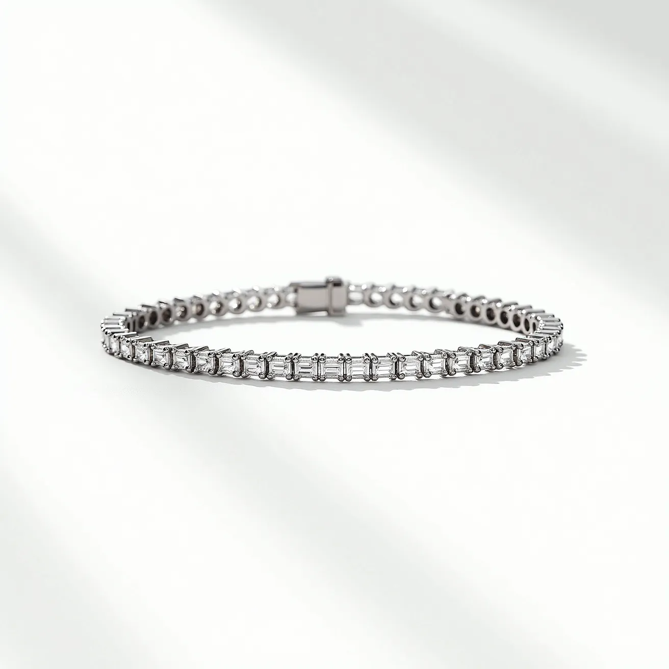 This diamond tennis bracelet features a sleek and elegant design, crafted in a precious metal, likely white gold or platinum, enhancing its brilliance. It is adorned with a series of rectangular baguette-cut diamonds, each carefully set in prong settings that accentuate the clean lines and sparkle of the stones. The bracelet is secured with a box clasp, ensuring a secure and seamless closure, which adds to its refined appearance. The uniformity and quality of the diamonds along with the meticulous craftsmanship make this piece an exquisite accessory.