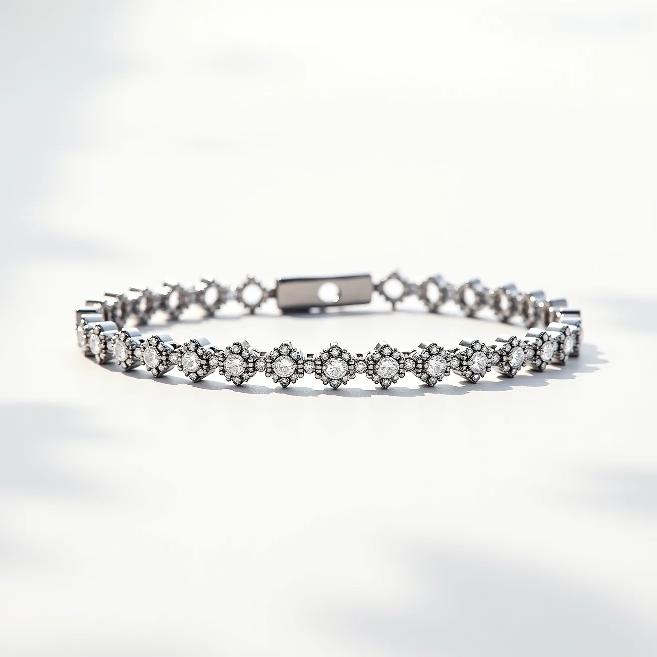 This diamond tennis bracelet features a series of round-cut diamonds arranged in a floral cluster setting, accentuated by smaller diamonds surrounding each central gem. The bracelet is crafted from a polished metal, likely white gold or platinum, lending an elegant and timeless look to the piece. Each diamond is securely set in a prong setting, ensuring both durability and maximal sparkle. The bracelet is equipped with a secure box clasp, offering a seamless and sophisticated closure mechanism. Overall, this piece exemplifies classic luxury with its intricate detailing and high-quality materials.