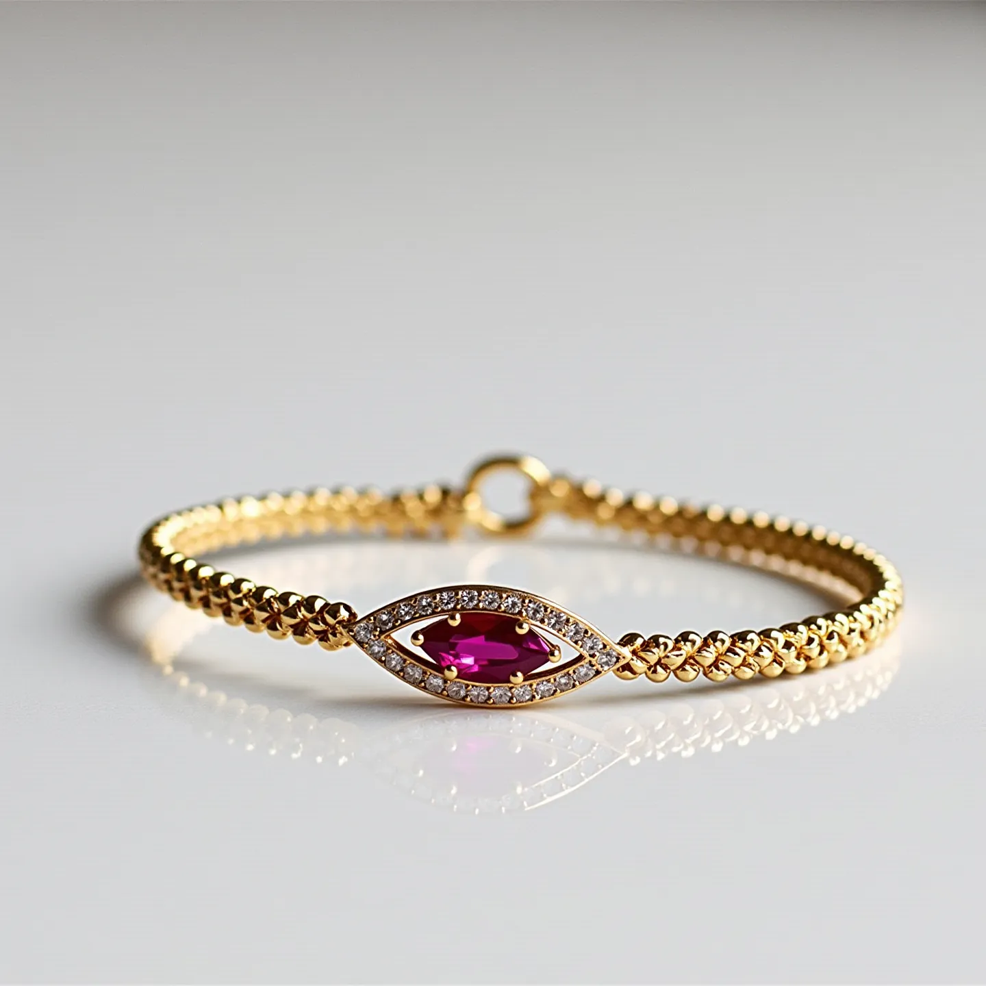 This gold beaded bracelet features a series of spherical beads crafted from what appears to be high-quality gold. At the center, it is adorned with an eye-catching marquise-cut gemstone, likely a ruby, held within a secure bezel setting. Surrounding the central gemstone is a border of small, sparkling diamonds set in a pavé style, enhancing the overall elegance and brilliance of the piece. The bracelet is equipped with a simple yet functional circular clasp, ensuring both security and ease of wear.