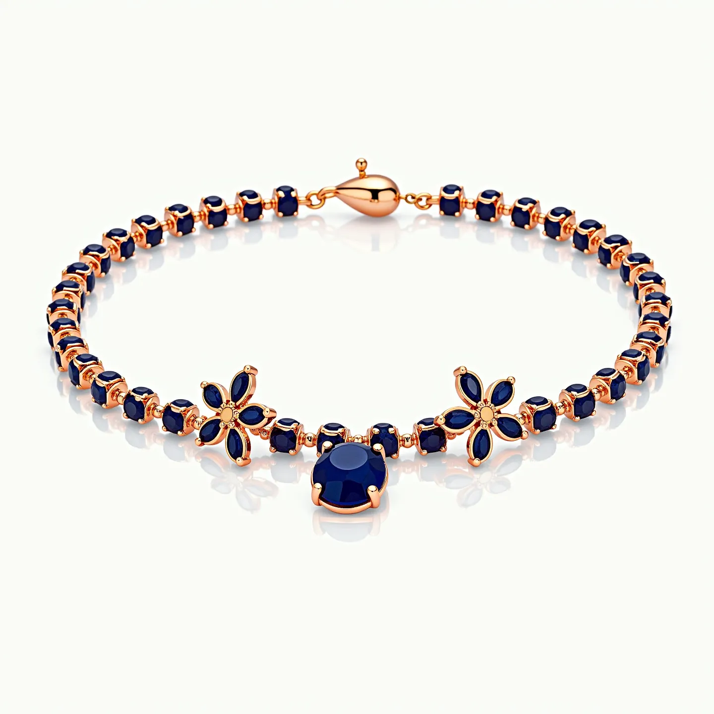 This gold beaded bracelet features numerous small, round, deep blue gemstones, each set into gold settings that link together to form the bracelet's chain. The bracelet is further accentuated by two flower motifs, each consisting of six petal-shaped deep blue gemstones arranged around a central gold bead. At the center of the bracelet lies a prominent oval deep blue gemstone in a classic prong setting, drawing focus to the middle of the piece. The bracelet is secured with a spring ring clasp that matches the gold hue of the settings, providing a cohesive and elegant finish to the design.