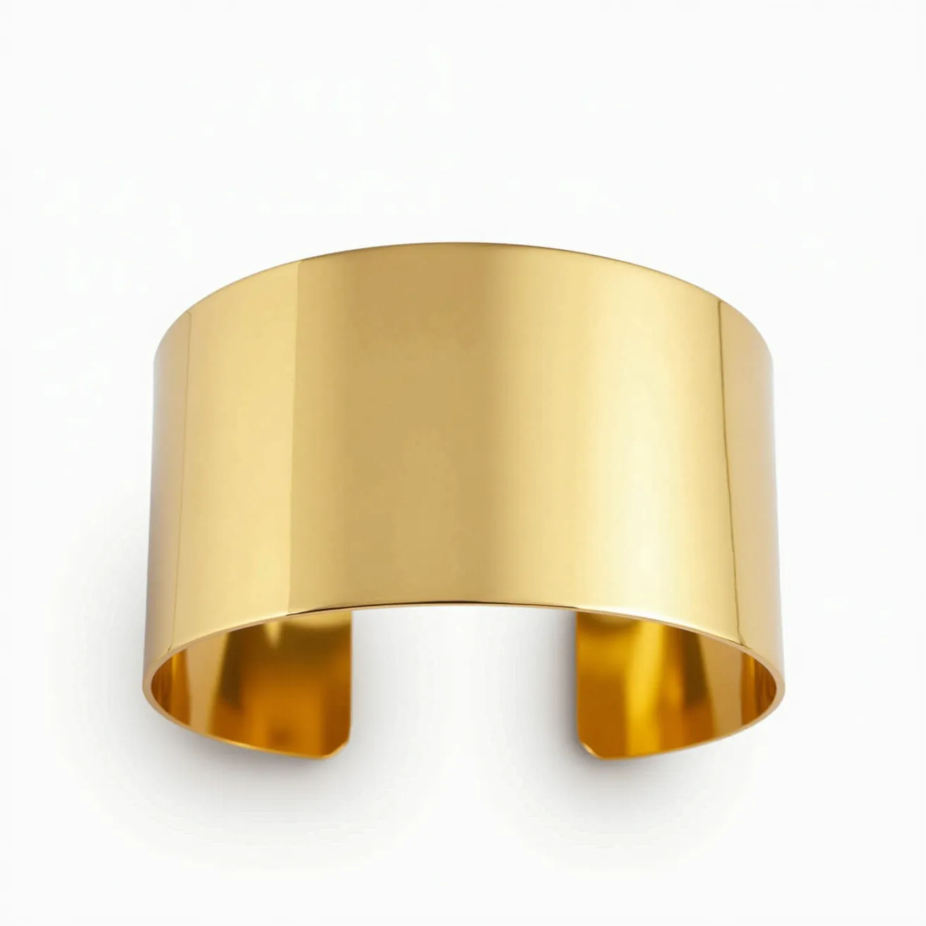 This gold cuff bracelet features a sleek and polished surface made from gold material. It is a wide cuff with a smooth, continuous band that curves gracefully to fit the wrist. The bracelet does not include any gemstones, settings, or additional decorative elements, emphasizing its minimalist and elegant design. It is an open cuff style, meaning it slides over the wrist without the need for a clasp or attachment mechanism.