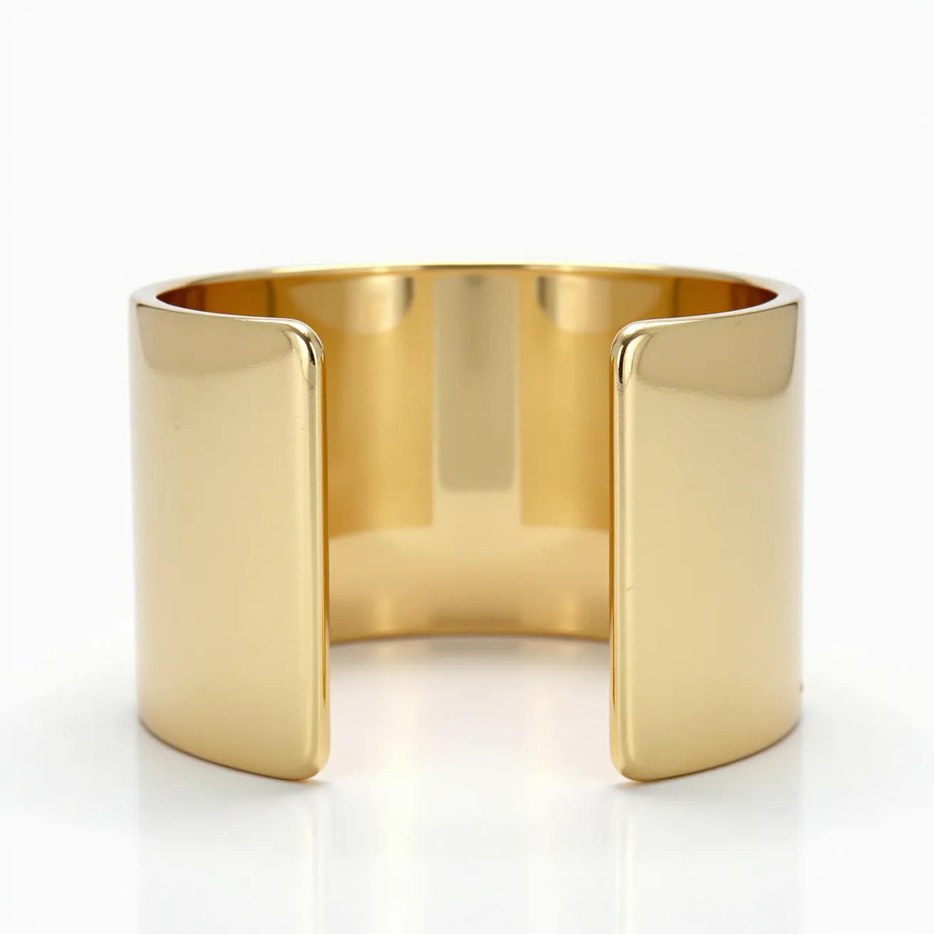 This gold cuff bracelet exhibits a sleek, polished design characterized by its broad, smooth surface with a high-gloss finish. The bracelet is made entirely of gold, providing a luxurious and elegant appearance. The edges are slightly rounded, enhancing its sophisticated aesthetic. It features an open-ended design that allows for easy adjustment and wearing, eliminating the need for a clasp or additional attachment mechanism. The clean lines and minimalistic approach make it a timeless piece suitable for various occasions.