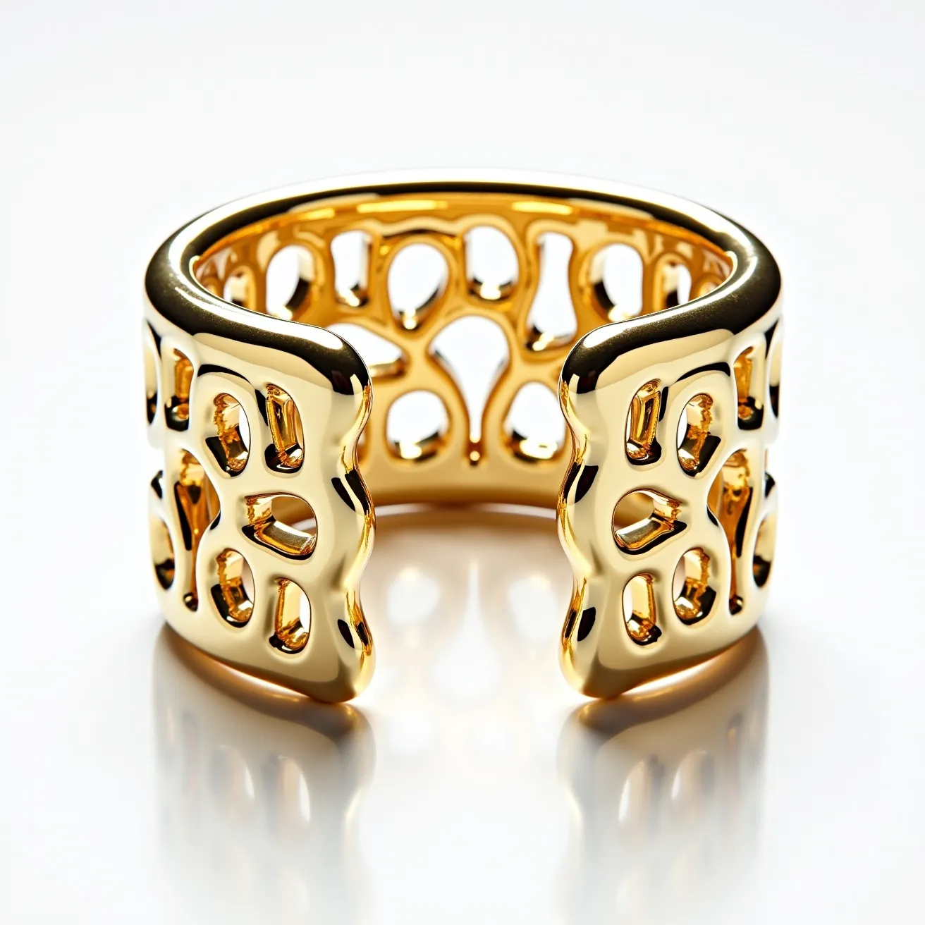 This gold cuff bracelet features an intricate openwork design with an organic, freeform pattern. The bracelet is crafted from polished gold, giving it a glossy and luxurious appearance. There are no visible gems or stones incorporated into the design. The bracelet does not have a clasp or attachment, as it is a cuff style that can be slipped onto the wrist. The combination of the high polish and the unique patterning contributes to its artistic and elegant aesthetic.