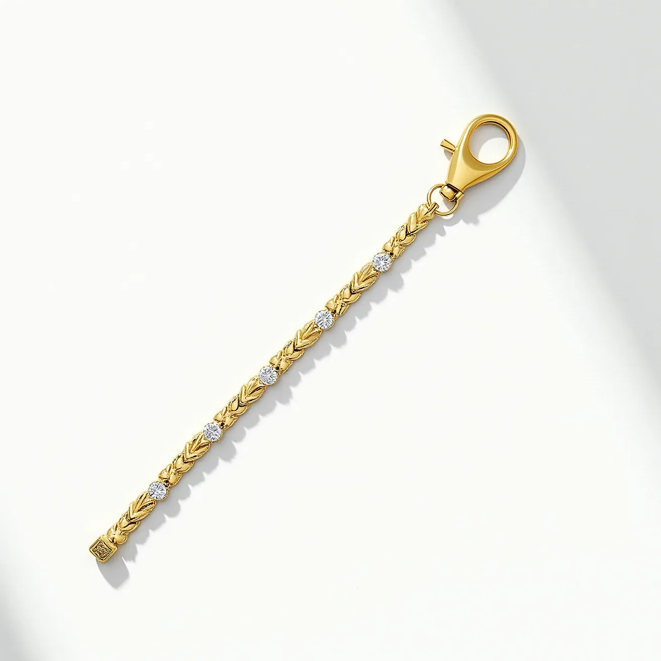 This gold tennis bracelet features a delicate and elegant design with a series of intricately patterned links crafted from gold. The bracelet is adorned with several round-cut gemstones, likely diamonds, which are evenly spaced and set in bezel settings, adding a touch of sparkle to the overall design. The clasp is a secure lobster claw style, ensuring ease of wear and durability. Each link of the bracelet showcases fine detailing, contributing to its sophisticated and luxurious appearance.