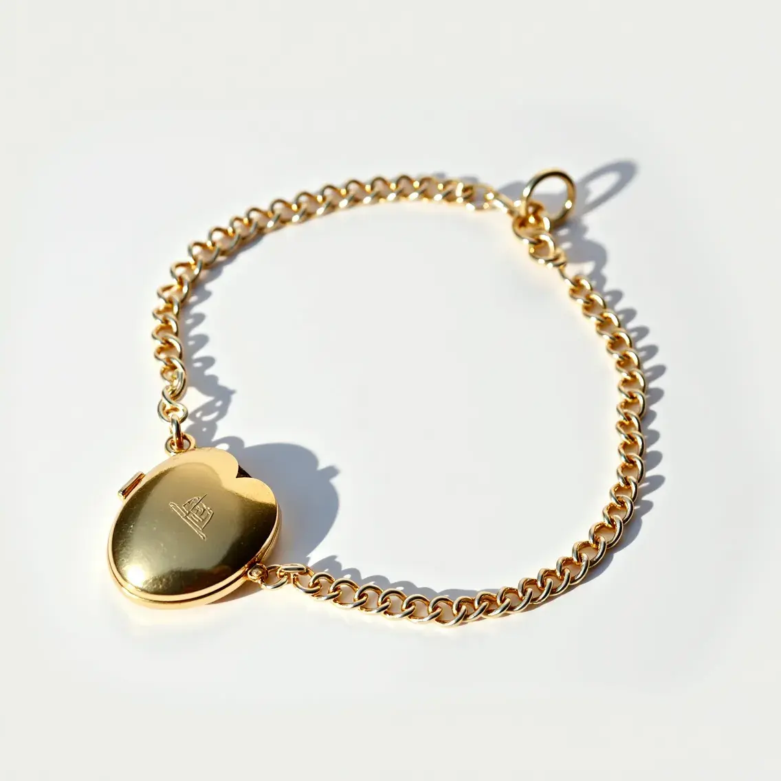 This locket bracelet features a heart-shaped pendant made of gold-toned metal, which is beautifully polished and embossed with a decorative design. The locket is attached to a chain formed from a series of oval links, also appearing to be crafted from the same gold-toned material. The locket itself appears to hinge open, allowing for the insertion of a small photo or keepsake. The bracelet closes with a circular spring ring clasp, which securely attaches to one of the chain links, ensuring that the bracelet remains fastened during wear.