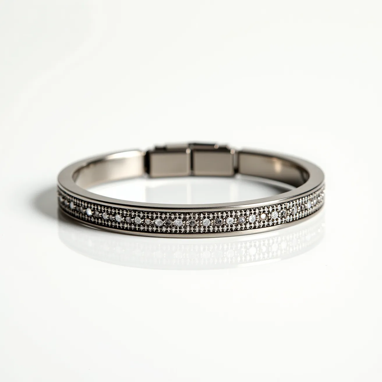 This men’s bracelet features a sleek design predominantly composed of a metal band. The central portion of the bracelet highlights a row of small, round-cut gems, potentially diamonds, set closely together in a pave setting, which gives it a refined and sparkling appearance. The gems are likely set in a line bordered by the metal on either side, enhancing the overall aesthetic. The bracelet is secured by a discreet and sturdy clasp mechanism, ensuring a secure fit while maintaining a seamless look.