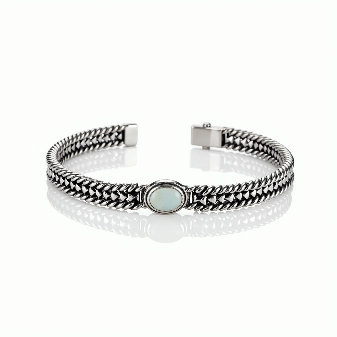 This men's bracelet features a robust chain made of polished metal, likely stainless steel, with a tightly interlinked design that creates a sleek, sophisticated look. At its center, there is an oval-shaped gemstone, potentially an opal or a similar stone, which exhibits a smooth, polished surface and is securely set within a bezel setting. The bracelet is equipped with a clasp mechanism designed to ensure a secure fit while maintaining the overall aesthetic cohesion of the piece.