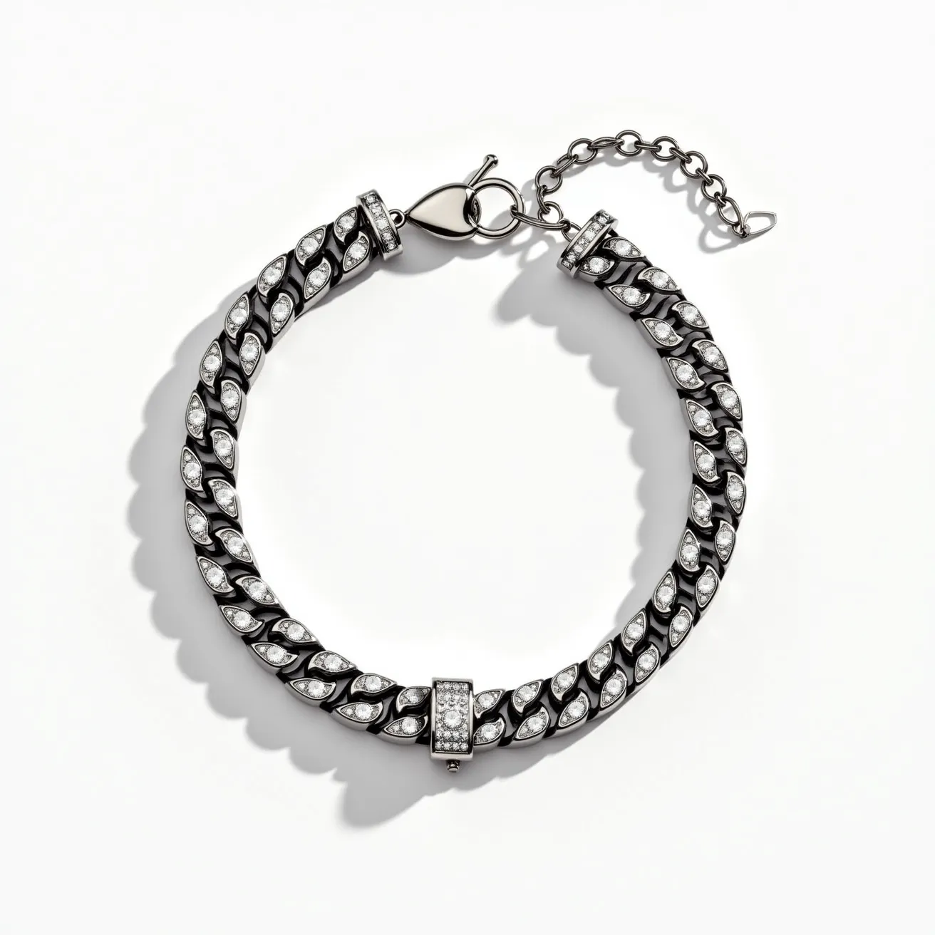 This men's bracelet showcases a robust chain link design, with each link elegantly embedded with small, white, round-cut gemstones, possibly diamonds, arranged in a pavé setting for added brilliance. The material of the links appears to be a polished metal, likely stainless steel or a similar durable alloy, enhancing its masculine appeal. The bracelet is secured with a lobster clasp, complemented by an additional safety chain, ensuring a secure fit on the wrist. The overall design merges both style and functionality, making it a versatile accessory for various occasions.