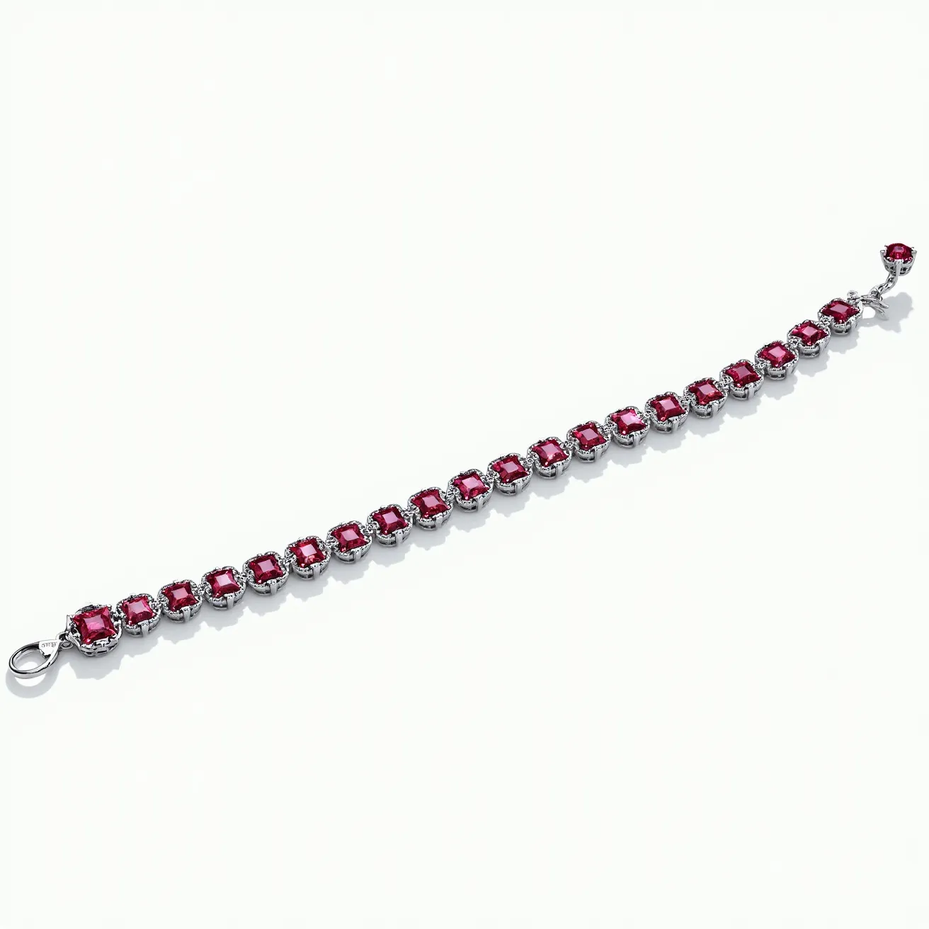 This tennis bracelet features a series of uniformly cut red gemstones, likely rubies, set in a continuous link. Each gem is faceted in a rectangular shape, with settings that secure them in a series of metal prongs, likely made from a type of polished silver or white gold, surrounding each stone to create a cohesive and elegant design. The bracelet is fastened by a clasp mechanism for secure wear around the wrist. The overall aesthetic showcases a classic and timeless piece of jewelry suitable for various formal occasions.