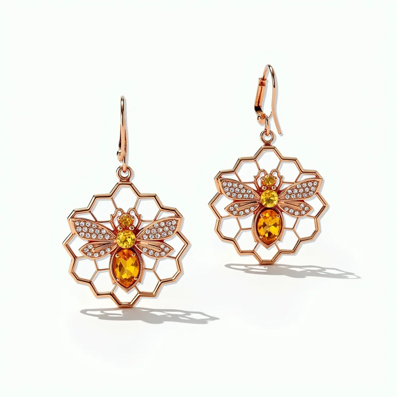 These bee earrings feature a detailed design incorporating a radiant combination of materials and gemstones. The bees are crafted with a metallic framework, likely of gold or gold-plated material, accentuating their intricate form. The body of each bee showcases an oval-cut amber or citrine stone, artistically set to capture light and add a warm, golden glow. The wings are adorned with pave-set clear stones, possibly diamonds or cubic zirconia, offering a sparkling contrast. These earrings are suspended from a simple yet elegant hook clasp attachment, ensuring a secure and comfortable fit. The overall design is both whimsical and luxurious, celebrating the beauty and intricacy of nature.