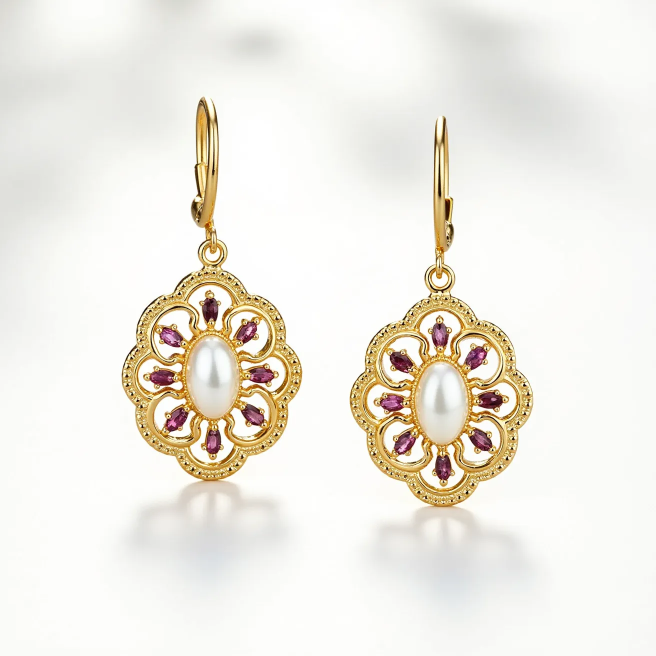 These birthstone earrings feature an elegant design with an ornate gold setting, showcasing an oval-shaped central pearl as the focal point of each earring. Surrounding the pearl are small, pear-shaped purple gemstones, likely amethysts, arranged symmetrically in a petal-like pattern. The gold setting has intricate detailing that enhances the vintage aesthetic. The attachment style is a lever-back clasp, providing a secure and graceful way to wear the earrings, complementing their overall sophisticated appearance.