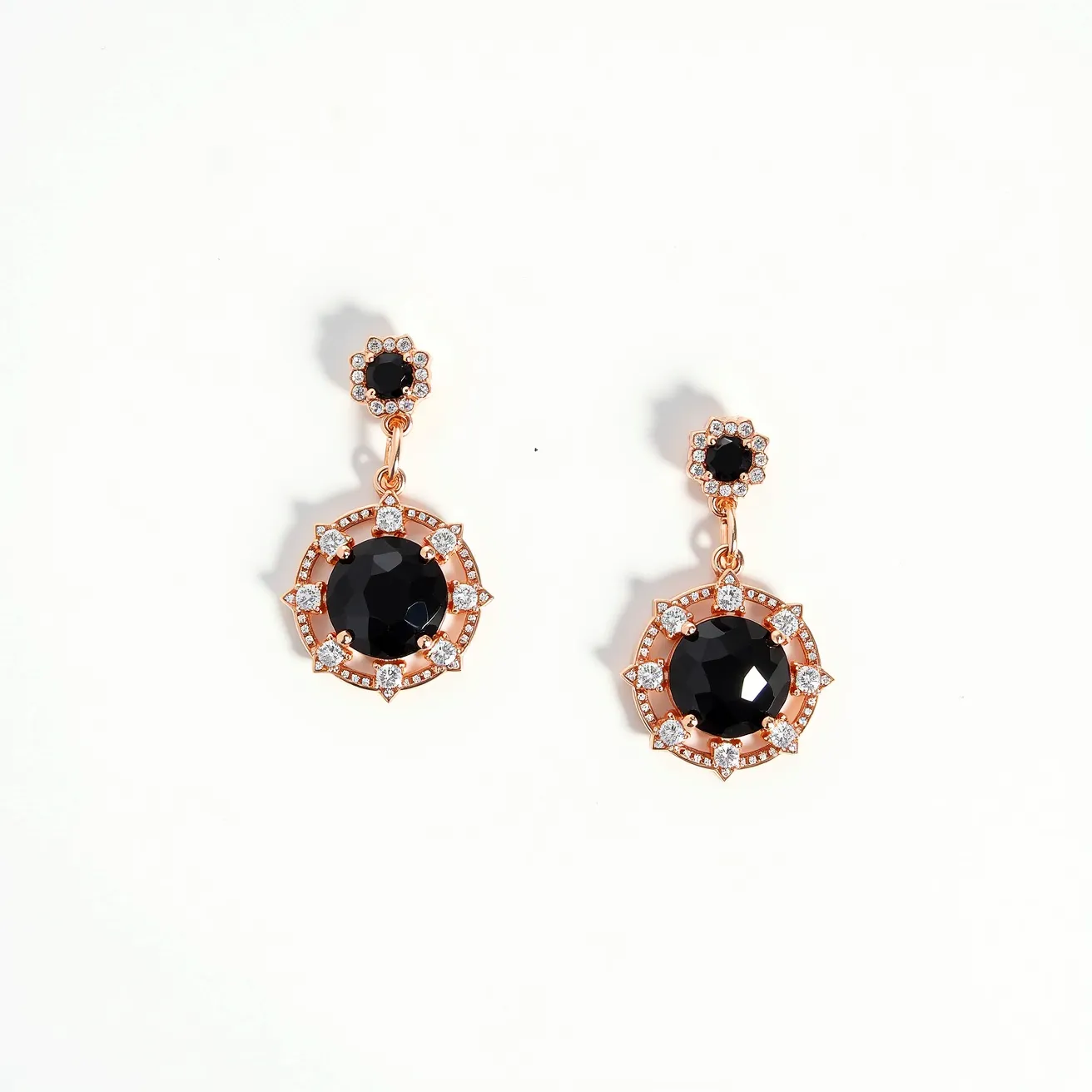 These black earrings feature a striking design composed of a large central black stone, likely onyx or a similar gem, surrounded by a rose gold setting. The stones are cut in a faceted style that enhances their shine and depth. Surrounding the central stones are smaller clear crystals set in the metal, adding a touch of brilliance and contrast. The earrings have a two-part structure with a small black stone at the top, also framed by clear crystals, connected to the larger piece below. They appear to be designed with a post and butterfly clasp attachment, making them secure and comfortable to wear.