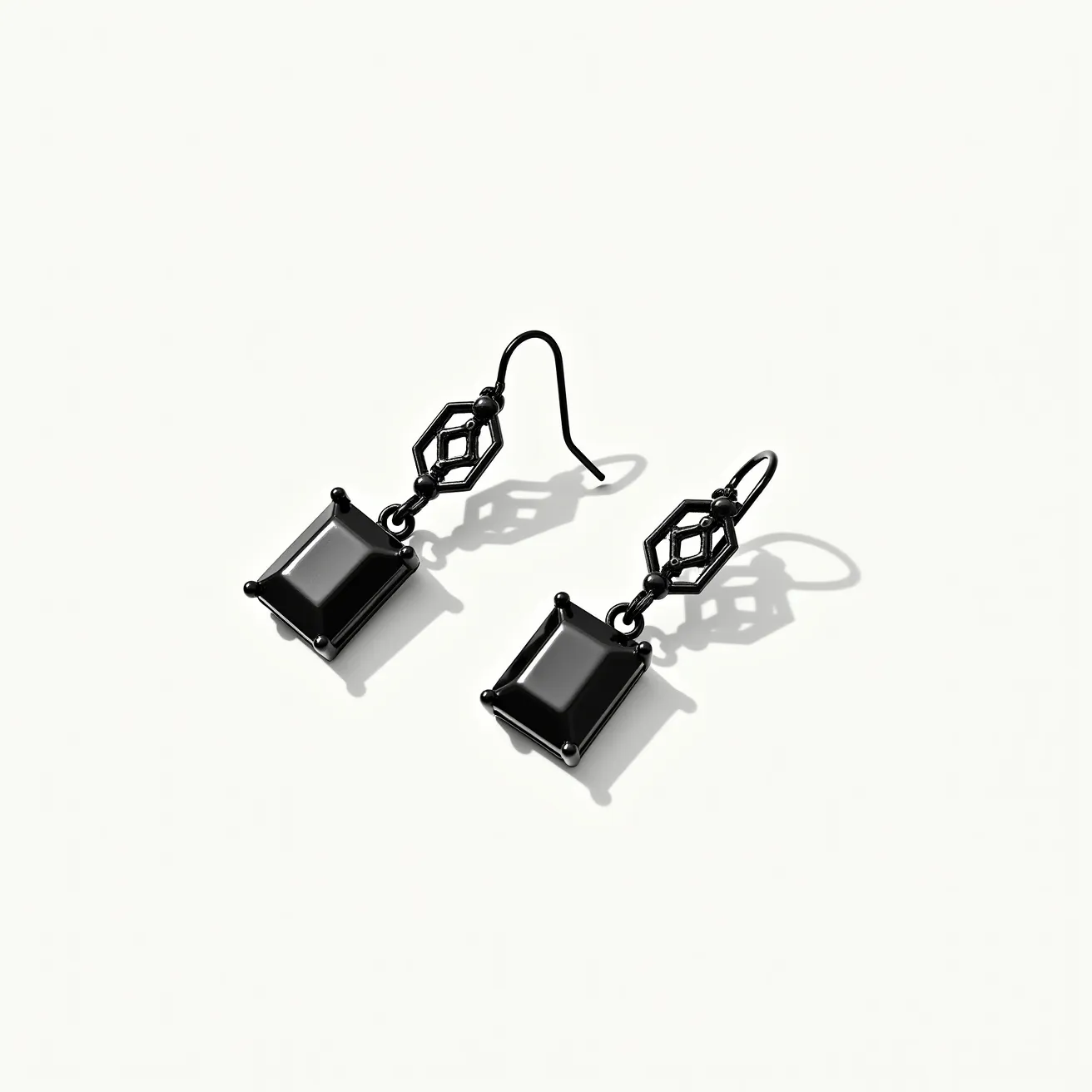 These black earrings feature a striking geometric design, centering around a prominent rectangular stone that is carefully set within a prong setting. The stone is deep black, suggesting the use of onyx or obsidian, with a smooth, polished finish that enhances its dark allure. Above the stone, an intricate hexagonal element adds an interesting architectural touch, echoing the earring's overall theme of elegance infused with modern simplicity. The attachment mechanism utilizes classic French hooks, ensuring both security and ease of wear. These components are all crafted from a material with a blackened finish, likely metal with a dark coating, which complements the stone's glossy surface and the earring's sophisticated style.