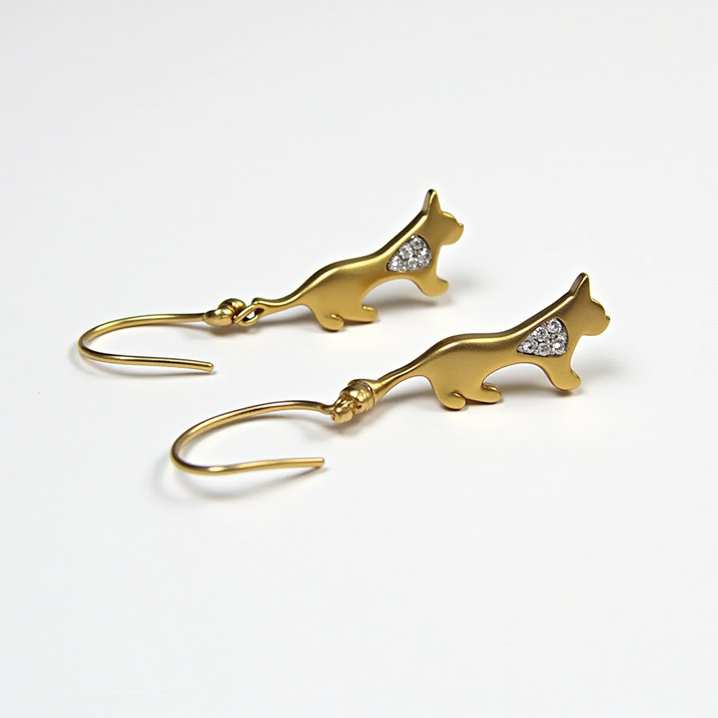 These cat earrings feature a charming design with a silhouette of a cat crafted from a gold-toned metal, providing a sleek and polished appearance. The body of each cat is embellished with small, sparkling stones set in a pave style, adding a touch of glitter and elegance. The earrings utilize a simple hook clasp for easy wearing, enhancing their practicality while maintaining their whimsical aesthetic. The overall design is both playful and sophisticated, making them a versatile accessory for various occasions.