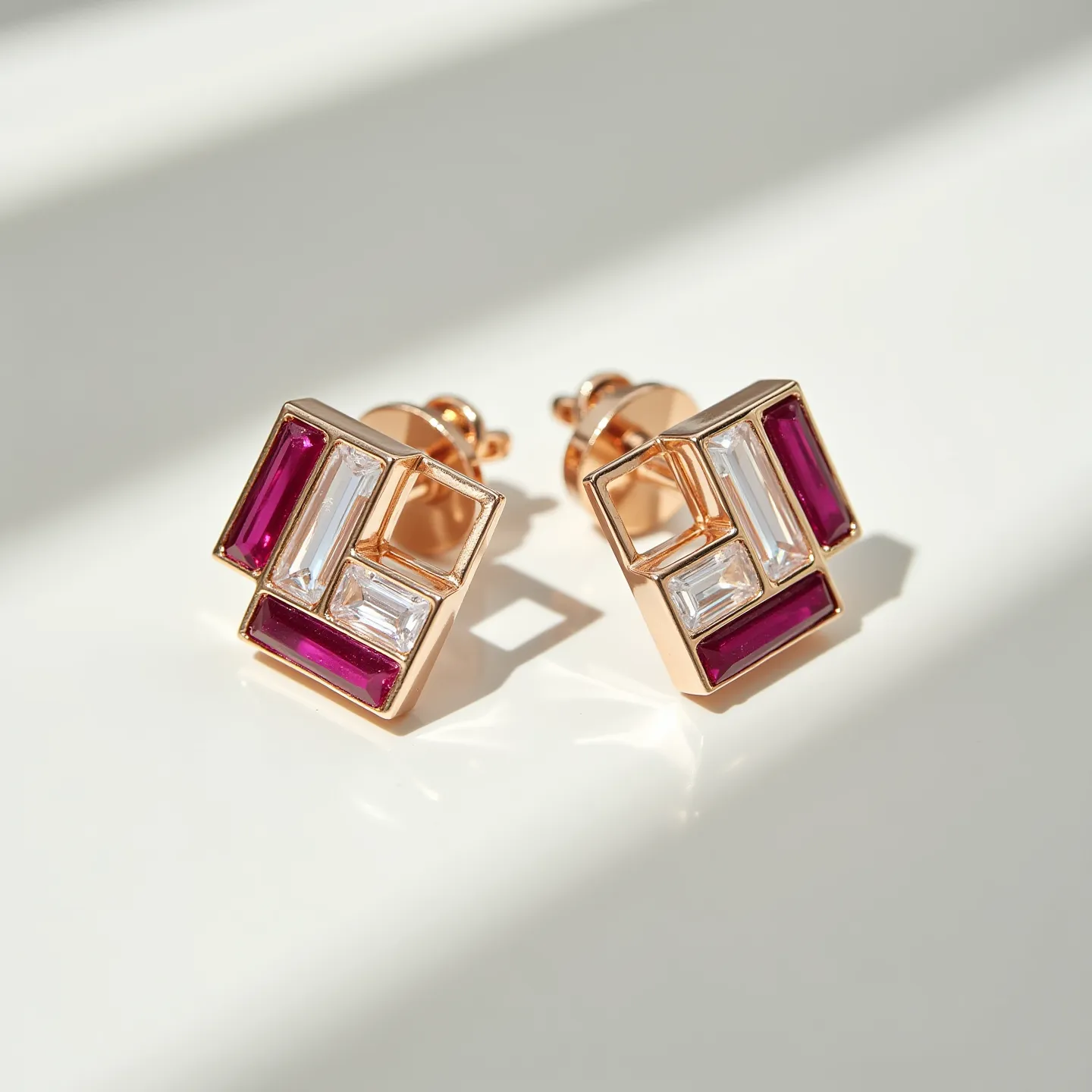 These clip on earrings features a geometric design composed of square and rectangular shapes. They are crafted with a gold-tone metal base that frames the stones elegantly. The earrings showcase vibrant red gemstones, likely rubies, set in baguette cuts alongside clear stones, possibly diamonds or cubic zirconia, also in baguette cuts. The stones are securely set in a channel setting, enhancing the modern aesthetic of the earrings. The clasp mechanism is a simple clip-on style, making them easy to wear without the need for pierced ears.