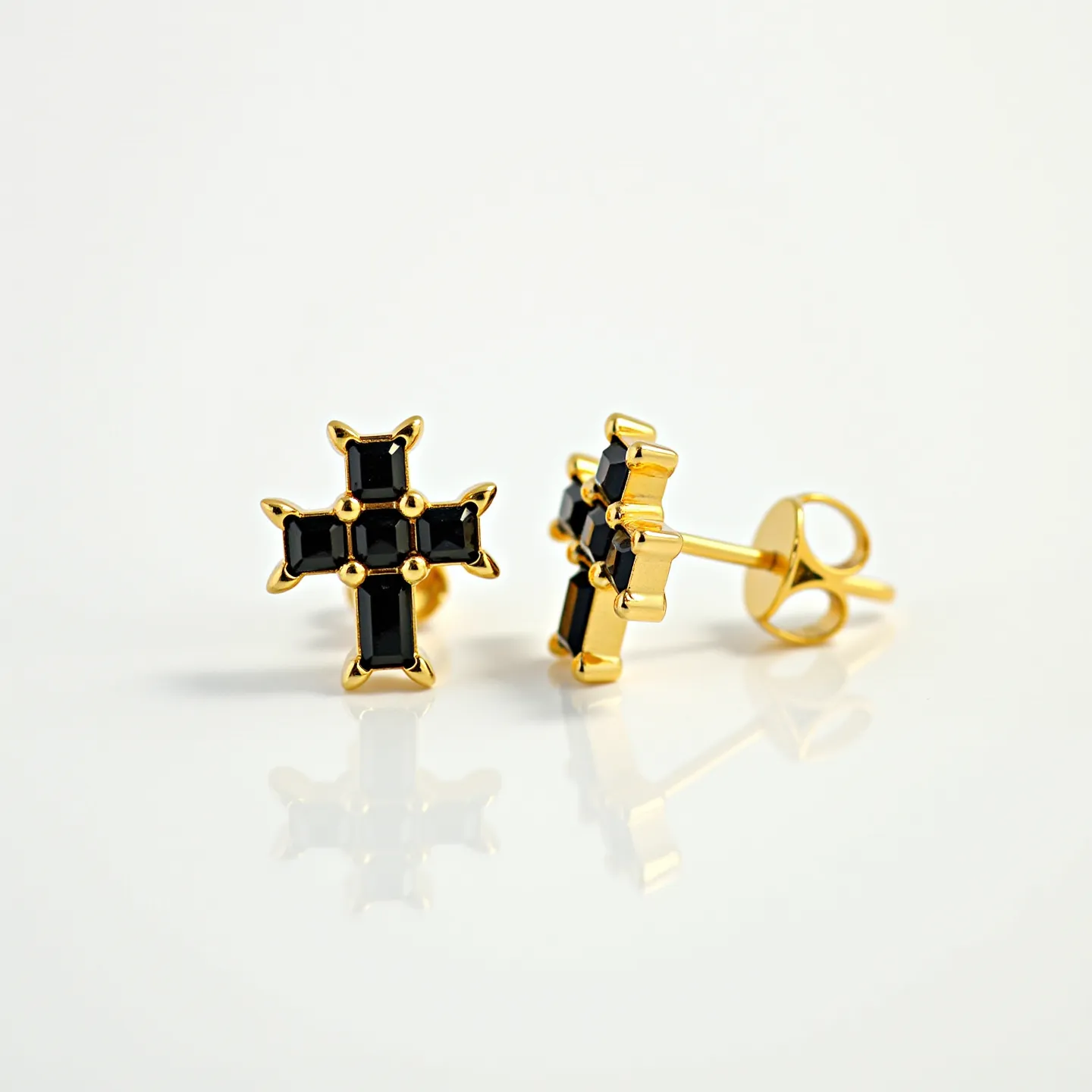 These cross earrings for men feature a striking design composed of glossy black stones, cut into rectangular shapes, arranged to form a cross. The stones are set in a gold-toned metal that adds an elegant touch to the overall aesthetic. Each corner of the black stone is securely held in place with prongs, ensuring durability and style. The earrings are equipped with a standard post and butterfly clasp, providing both security and ease of wear. The combination of black and gold creates a bold and sophisticated look suitable for various occasions.