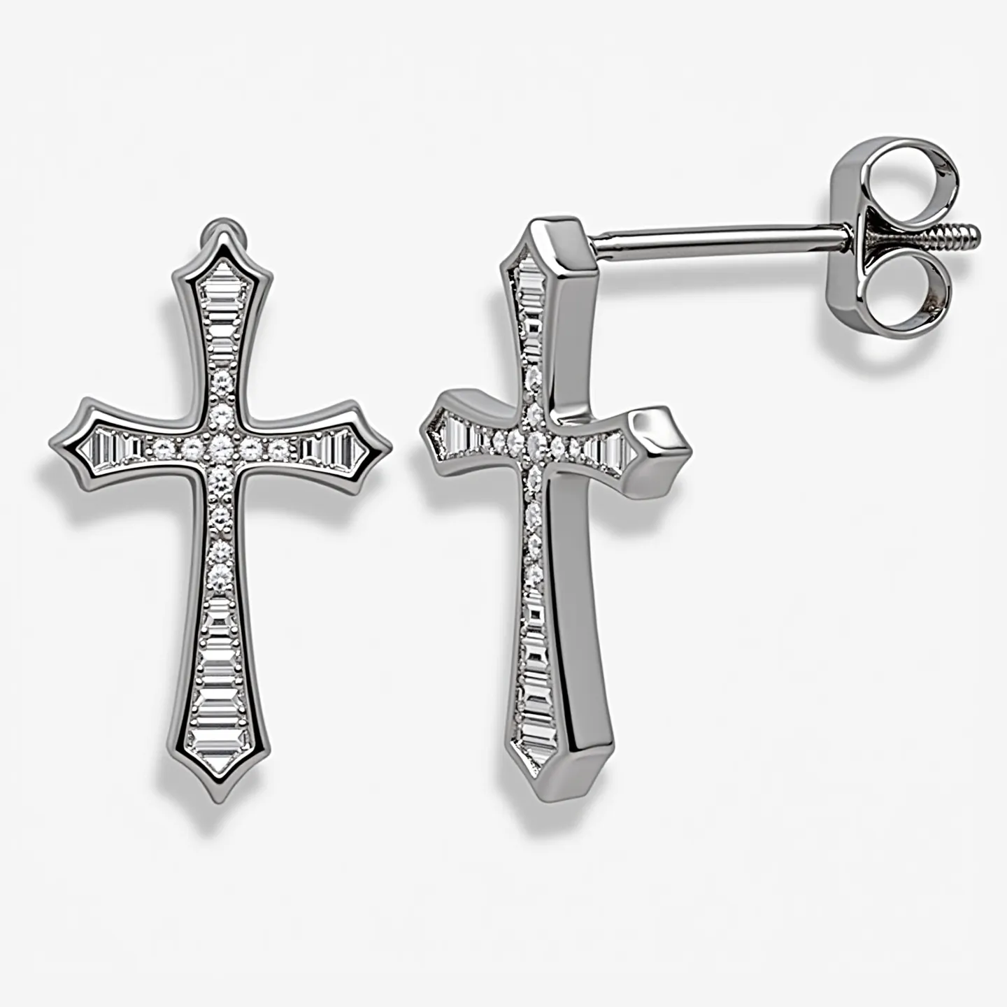 These cross earrings for women feature a sleek and elegant design crafted from a shiny metallic material, likely sterling silver or white gold. The cross shape is adorned with a series of small, round-cut diamonds set along the central line, which add a sparkling effect to the piece. Additionally, baguette-cut diamonds are embedded along the cross arms, enhancing its sophistication and brilliance. The earrings have a straightforward post and butterfly back attachment, ensuring a secure and comfortable fit. The combination of cut and setting highlights the geometric symmetry and reflective quality of the earrings, making them a striking accessory.