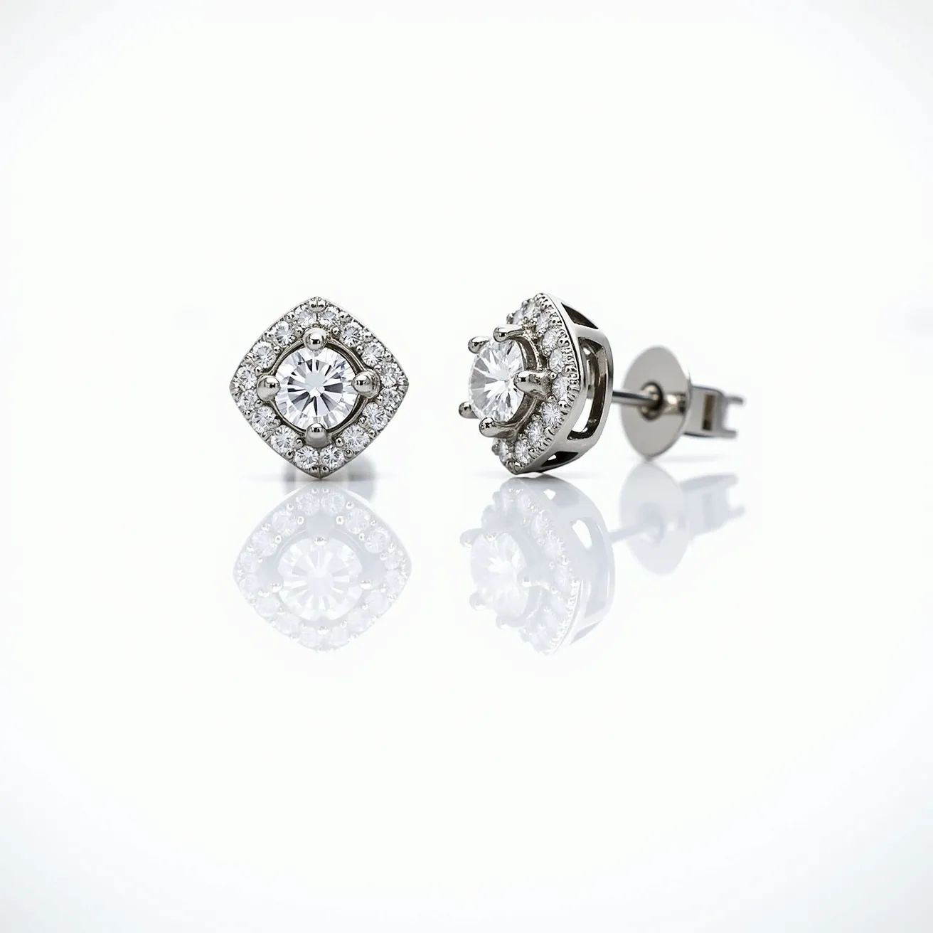 These diamond earrings feature a central round-cut diamond, securely set in a prong setting that enhances its brilliance. The central stone is surrounded by a halo of smaller, round-cut diamonds, adding extra sparkle and dimension to the design. The halo is set in a cushion shape, giving the earrings a balanced and elegant appearance. The earrings are crafted in a shiny metal, likely white gold or platinum, which complements the diamonds' clarity and shine. They are equipped with a classic post and butterfly back, ensuring a secure and comfortable fit on the ear.