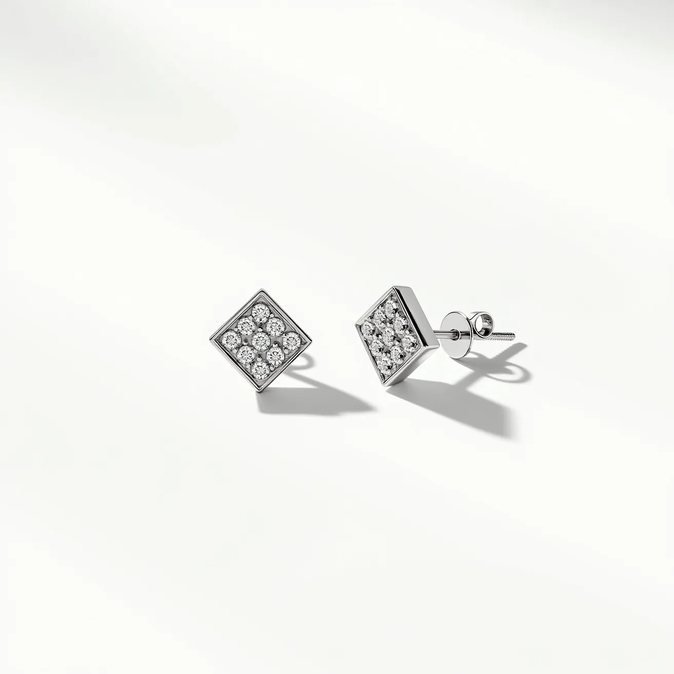 These pair of diamond earrings features a classic and elegant design with a square shape. Each earring is adorned with a cluster of small, round-cut diamonds set closely together, creating a brilliant sparkle. The stones are set in a precious metal, likely white gold or platinum, which complements the diamonds' brilliance. The earrings are equipped with a stud post and secured with a butterfly or push-back clasp, ensuring a secure fit. The use of multiple stones in a geometric arrangement adds a contemporary touch to the timeless appeal of these earrings.