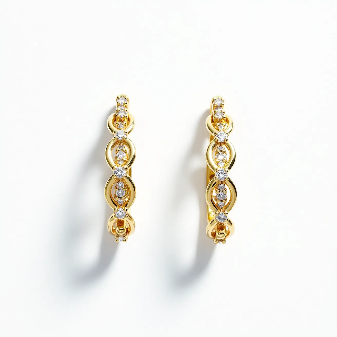 These diamond earrings showcase a delicate design, featuring a series of round-cut diamond stones intricately set along a gold loop structure, enhancing their brilliance. Each earring appears to be composed of horizontal gold links accented with multiple diamonds, which are possibly set in a prong setting to allow for maximum sparkle and light reflection. The gold used in the construction complements the diamonds, offering a luxurious and elegant appearance. The earrings are designed as hoops, likely incorporating a hinged clasp or snap closure for secure and comfortable wear.