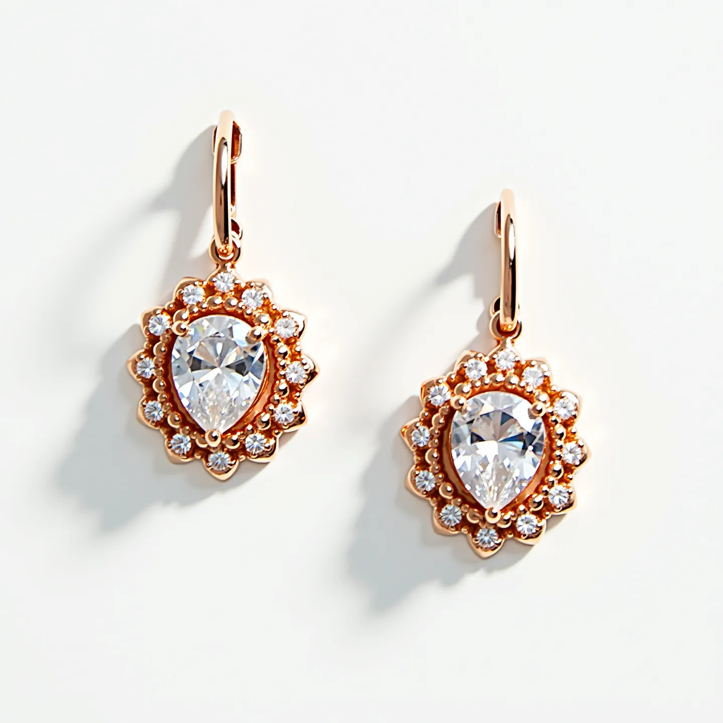 These diamond earrings showcase a stunning pear-shaped diamond as the central stone, accentuated by a surrounding halo of smaller round-cut diamonds. The earrings are set in what appears to be a rose gold metal, enhancing the brilliance of the diamonds. The design features a classic lever-back clasp, providing both security and elegance. The combination of the pear cut with the round-cut halo creates a sophisticated and timeless look, making these earrings an exquisite piece of jewelry.