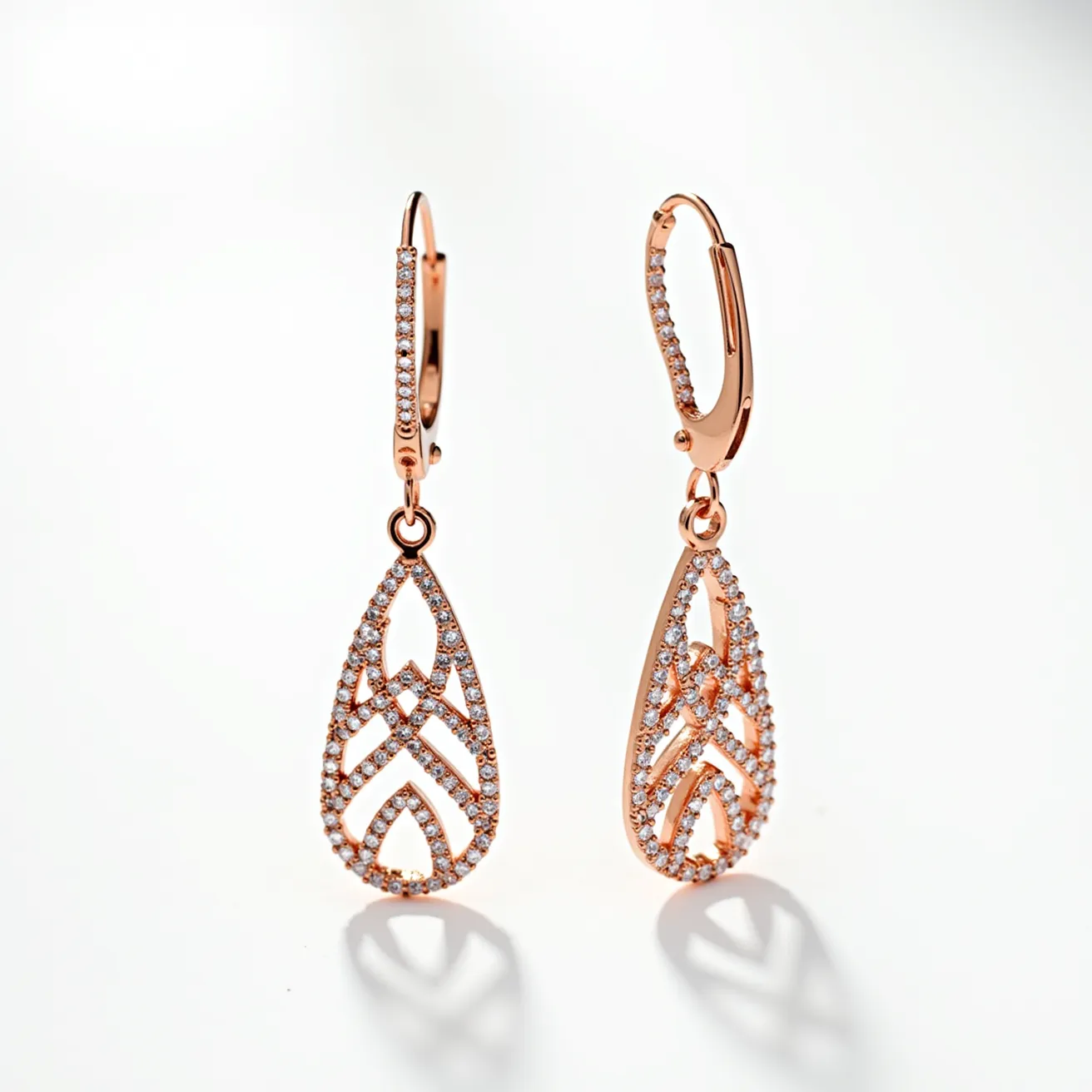 These drop earrings showcase an elegant design crafted from rose gold, featuring a delicate openwork pattern. The earrings are adorned with numerous small, round-cut diamonds that are meticulously set in a pavé style throughout the teardrop shape, creating a shimmering effect. The attachment mechanism involves lever-back clasps, ensuring a secure and comfortable fit for the wearer. The combination of rose gold and diamonds adds a touch of sophistication and luxury to the overall appearance of the earrings.