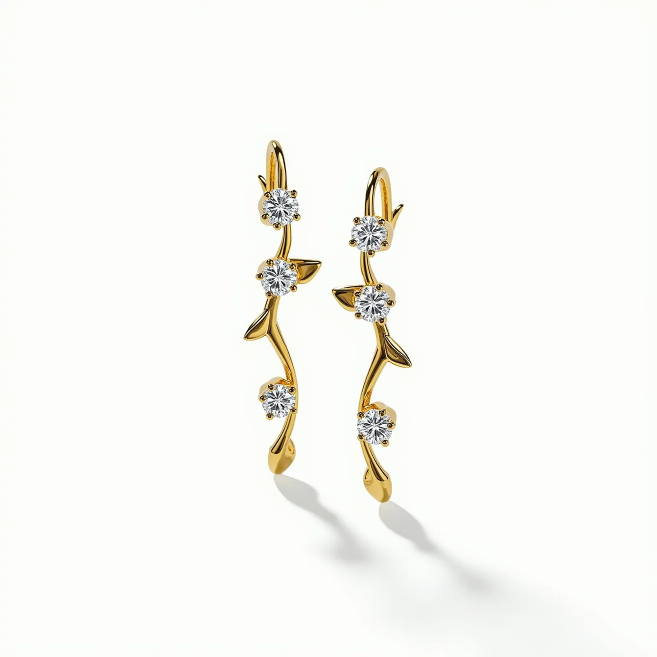 These floral earrings are crafted from a polished gold metal, featuring an elegant vine-like design. Adorning the structure are multiple round-cut clear stones, set in a claw setting to enhance their brilliance. The pattern mimics a delicate arrangement of flowers and leaves, contributing to the natural, botanical theme. The earrings have a hook attachment, which allows for easy wear and secure placement on the ears. This design combines the timeless appeal of gold with the sparkling allure of gemstones, creating a sophisticated accessory.