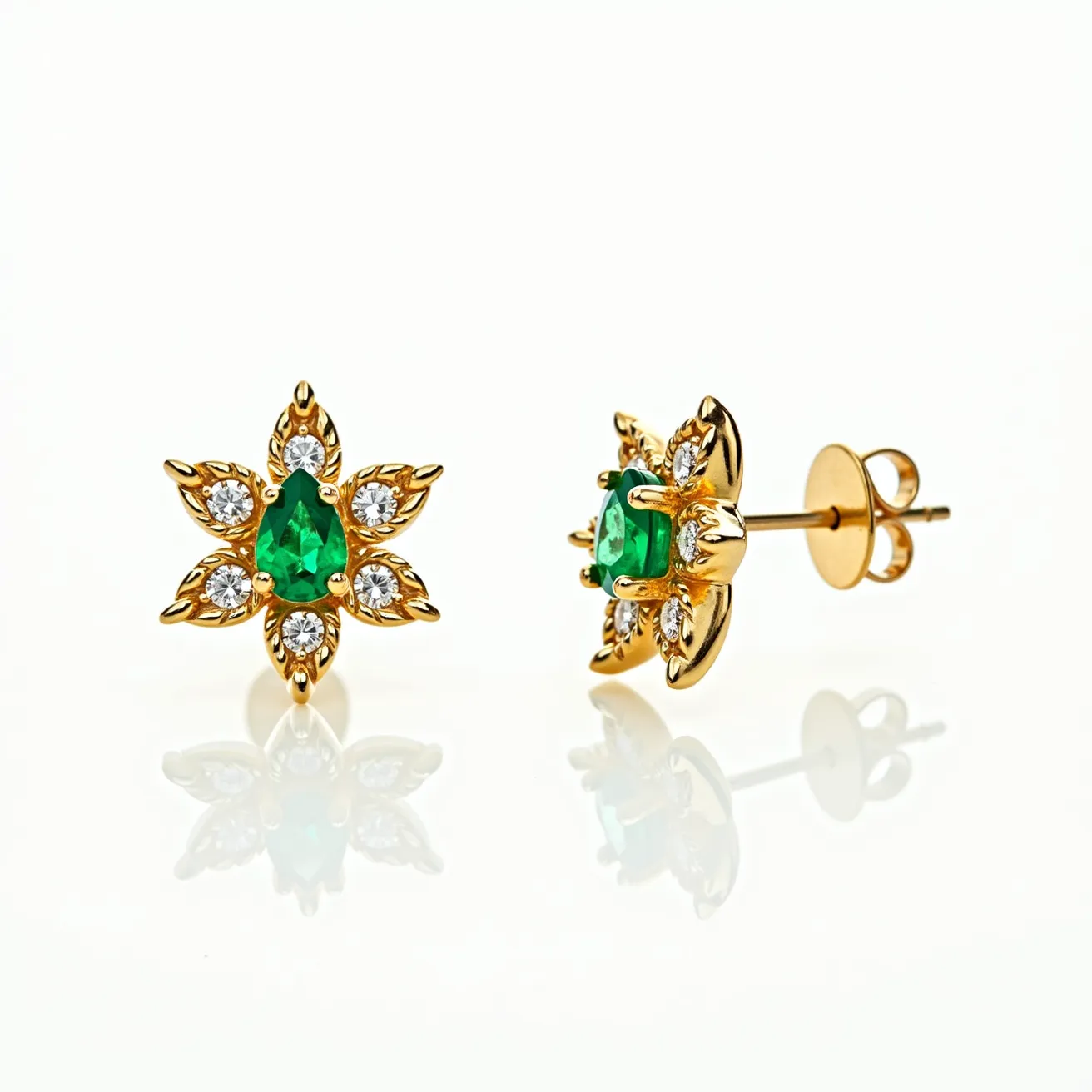 These floral stud earrings feature a captivating design crafted from gold, with each piece shaped like a flower. At the center of each earring is a vibrant green pear-shaped gemstone, likely an emerald, secured with a prong setting. Surrounding the central gem are smaller round brilliant-cut white stones, possibly diamonds, enhancing the floral motif with their sparkle. The earrings are designed with a classic post and butterfly clutch attachment, providing secure and comfortable wear. The intricate design and choice of materials combine to create an elegant and timeless accessory.