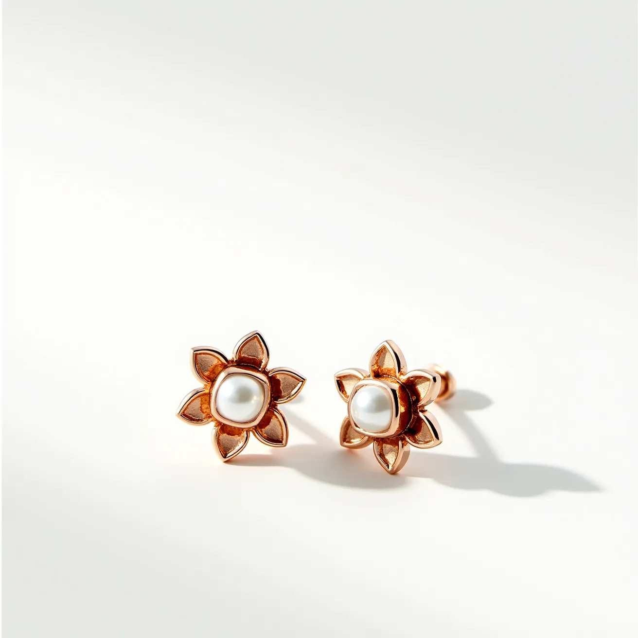 These gold cartilage earring features a delicate floral design with a central pearl-like gem as its focal point. The petals of the flower are crafted from gold, giving a warm and luxurious sheen to the piece. The pearl is smooth and round, set prominently in the center, emphasizing its luster. The setting is likely a bezel type, securely holding the pearl while enhancing its appearance. The earring uses a stud style attachment, providing a snug and secure fit for cartilage piercings, making it both practical and elegant for everyday wear.