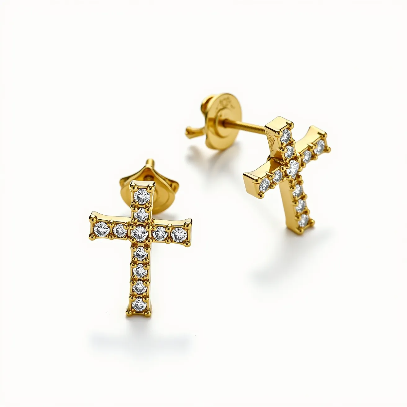 These gold cross earrings are crafted from a lustrous yellow gold, featuring a series of round, brilliant-cut stones that are set into the cross structure. Each stone is securely held in place by prongs, accentuating the intricate design and adding a touch of elegance. The earrings are attached using a classic push-back clasp, ensuring both comfort and security when worn. The combination of sparkling stones and polished gold creates a striking and timeless accessory.