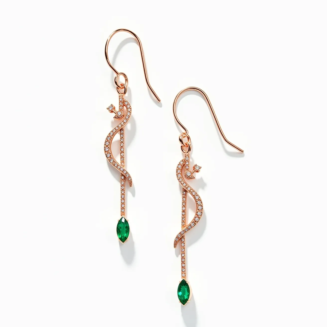 These gold dangle earrings feature an intricate and elegant serpent-like design, crafted from rose gold metal. The earrings are gracefully set with numerous small, clear gemstones that accentuate their shimmering appearance. At the tip of each earring hangs a striking marquise-cut gemstone, showcasing a rich green hue, likely an emerald or a similarly colored stone. The earrings are secured with a fishhook clasp, providing a secure yet easy-to-wear attachment.