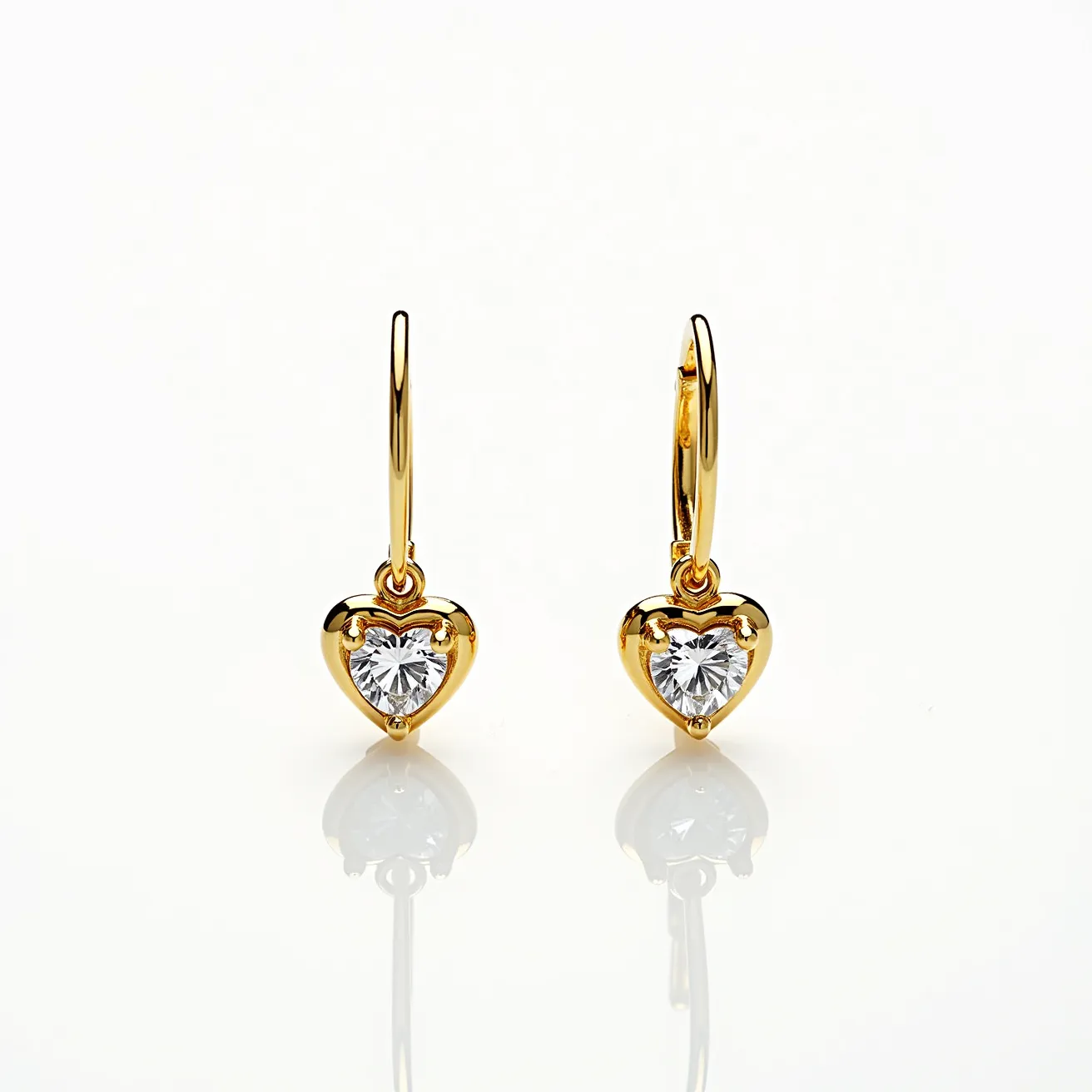 These gold heart earrings feature a delicate heart shape crafted from gold, elegantly showcasing sparkling, heart-cut gems. The gems are securely set in a three-prong setting, enhancing their brilliance and symmetry. The earrings are designed with a simple hoop attachment, allowing them to dangle gracefully. The overall design exudes timeless elegance, making these earrings a charming accessory for any occasion.