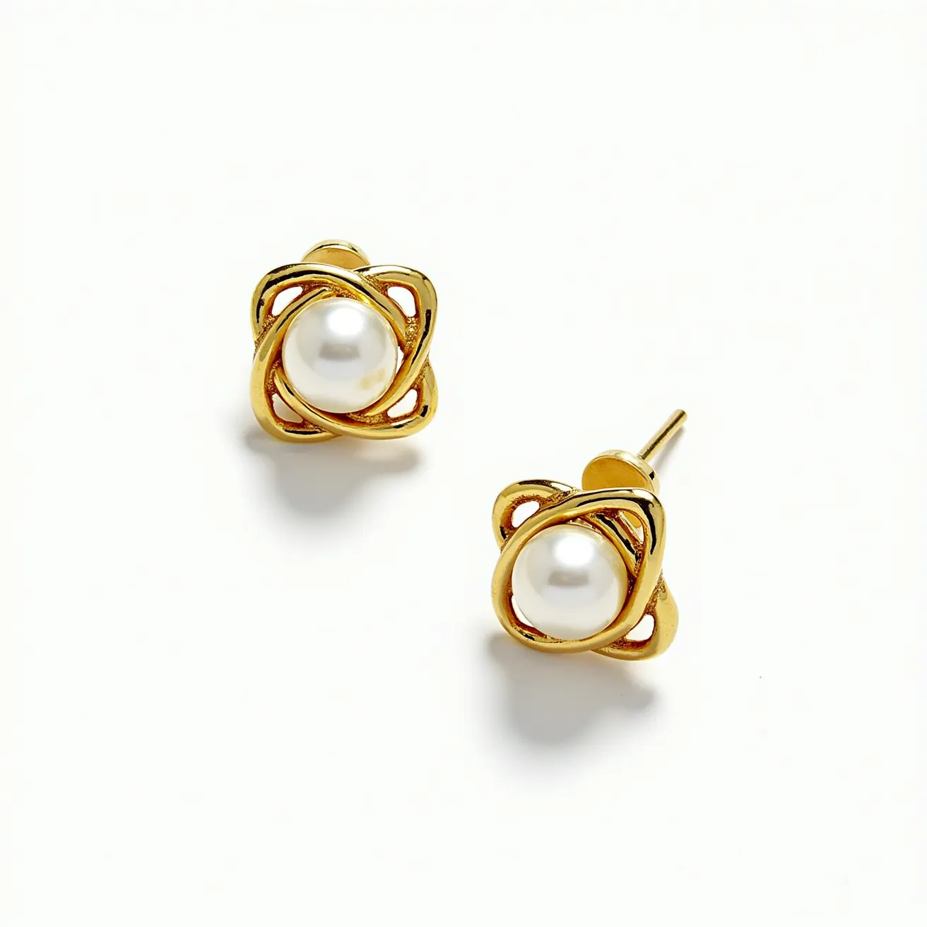 These gold knot earrings feature a sophisticated design crafted from gold, forming an intricate knot pattern that encases a central spherical gem. The gem appears to be a smooth, polished pearl, which complements the warm tone of the gold setting. The pearls are not faceted, maintaining their classic and elegant appeal. These earrings attach to the ear with a simple post backing, providing a secure and comfortable fit. The overall design is timeless, combining the luxurious materials of gold and pearl to create a versatile and elegant accessory.