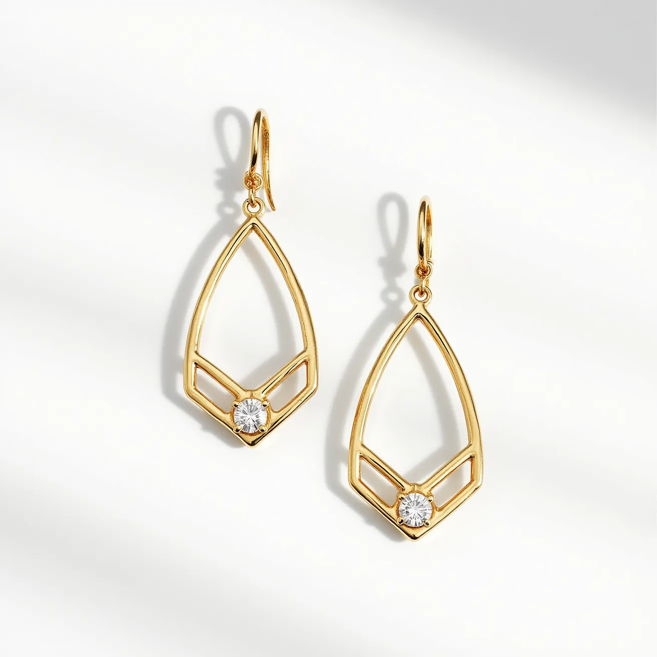 These gold teardrop earrings feature a sleek, open framework crafted from a polished gold material, showcasing a minimalist and elegant design. At the apex of the teardrop, a single round-cut gemstone is prominently set within a bezel setting, adding a touch of sparkle and sophistication to the piece. The earrings are suspended from a simple hook clasp, contributing to their graceful and lightweight appearance. The combination of geometric lines and a single sparkling gem creates a modern yet timeless jewelry piece.