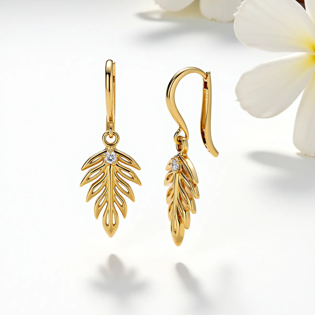 These gold teardrop earrings feature an elegant, openwork leaf design crafted from polished gold, exuding a timeless sophistication. Each earring is adorned with a small, round-cut diamond at the top, securely set in a prong setting that enhances its sparkle and elegance. The earrings are designed with a smooth, curved lever-back clasp, ensuring both security and comfort when worn. Their graceful form and delicate details make these earrings a stunning accessory for any occasion.