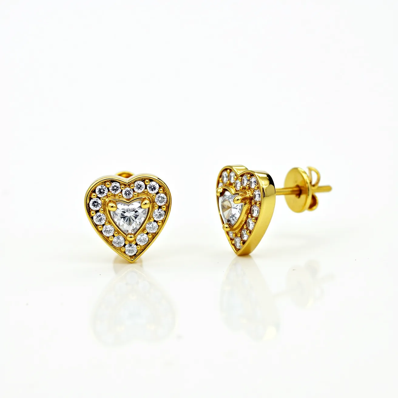 These heart diamond earrings feature a captivating design with a central heart-shaped diamond as the focal point, set in a bezel setting. Surrounding the central stone, a halo of smaller round diamonds enhances the brilliance and adds depth to the piece. The earrings are crafted with a gold metal, which provides a rich and elegant contrast to the shimmering stones. They are secured with a classic post and butterfly back clasp, ensuring a comfortable and secure fit. The combination of heart and round cuts, along with the thoughtful setting, creates a romantic and timeless appeal.