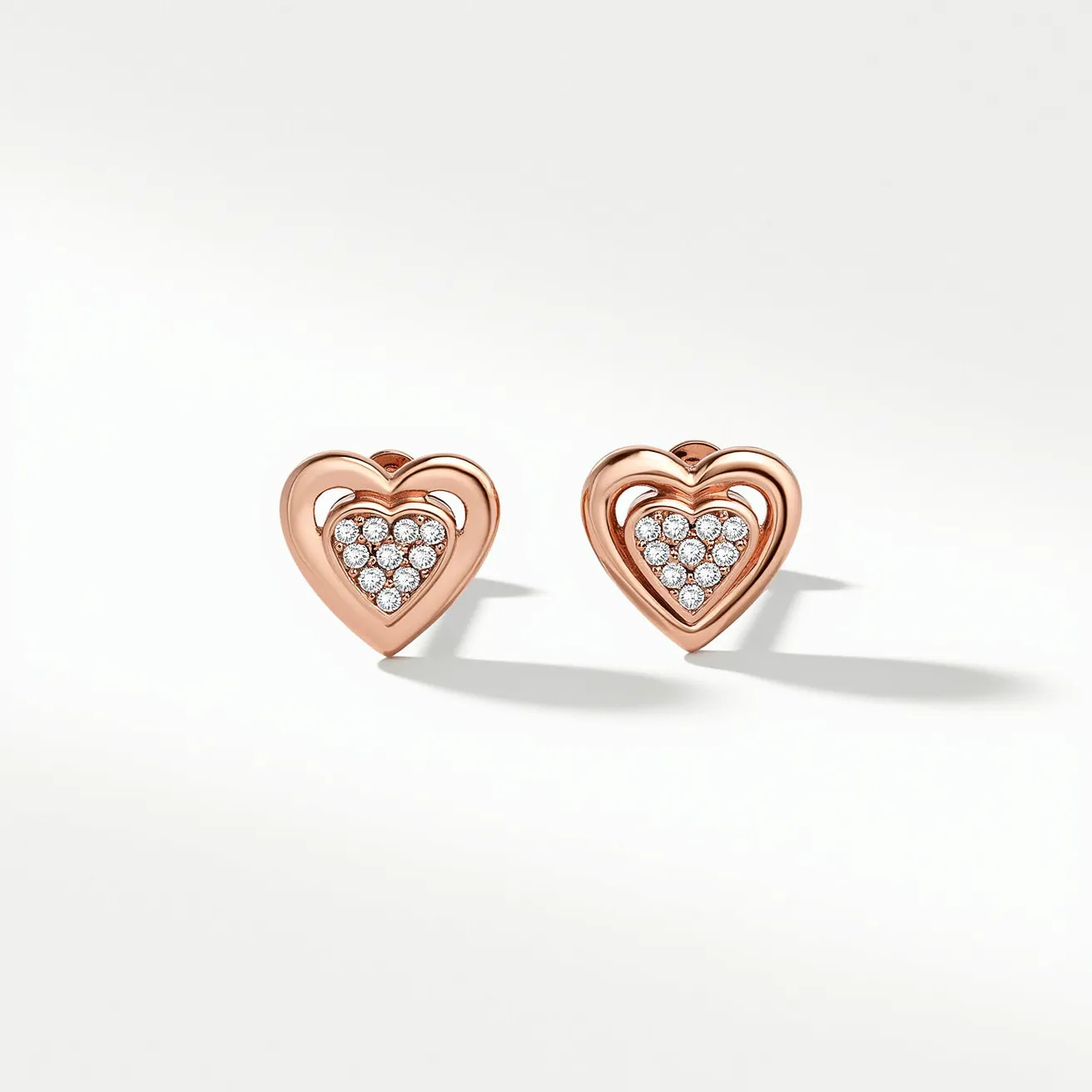 These heart earrings are crafted from what appears to be rose gold, forming an elegant heart-shaped outer frame. Inset within each heart are small, round-cut diamonds arranged closely together in a pavé setting, adding a sparkling effect. The earrings feature a traditional post and butterfly back fastening, ensuring they are securely attached when worn. The overall design blends warmth and sophistication, making them a charming accessory choice.