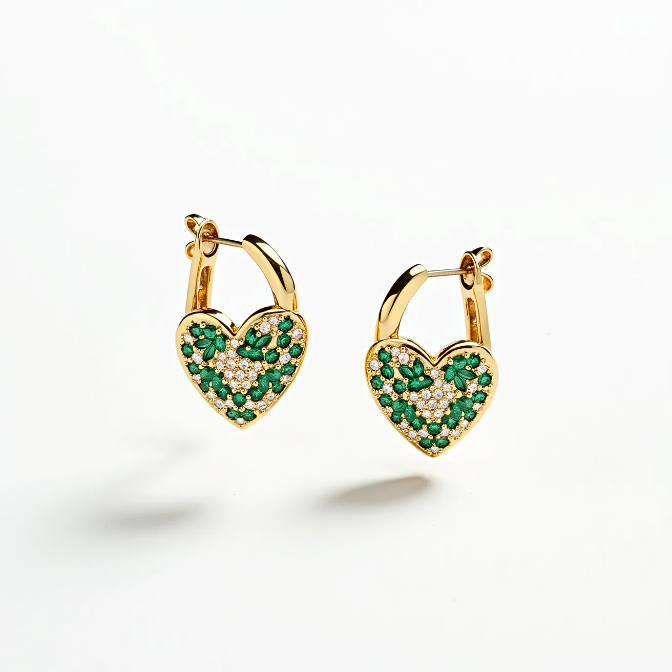 These heart hoop earrings feature a vibrant and elegant design with a gold-toned metal forming the body of the hoops. Adorning the heart-shaped section are clusters of green and clear gemstones, likely emeralds and diamonds or diamond-like stones, set in a pave style that creates a shimmering effect. The green stones are cut in a round shape, nestled closely among the clear stones, enhancing the contrast and visual appeal. The earrings are equipped with a hinged hoop clasp, ensuring secure and comfortable wear. The design combines classic elegance with a modern twist, making them a striking accessory for any occasion.