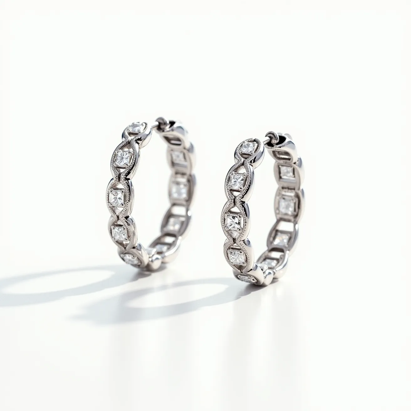 These helix hoop earrings are elegantly crafted from a polished silver-toned metal, featuring a series of radiant, round-cut gems intricately set along the band. Each gem is nestled securely within an individual bezel setting, showcasing a thoughtful attention to detail that enhances the earrings' luxurious appeal. The hoops are designed with a clasp mechanism that ensures a secure and comfortable fit when worn. The overall design reflects a sophisticated blend of classic and contemporary styles, suitable for various occasions.