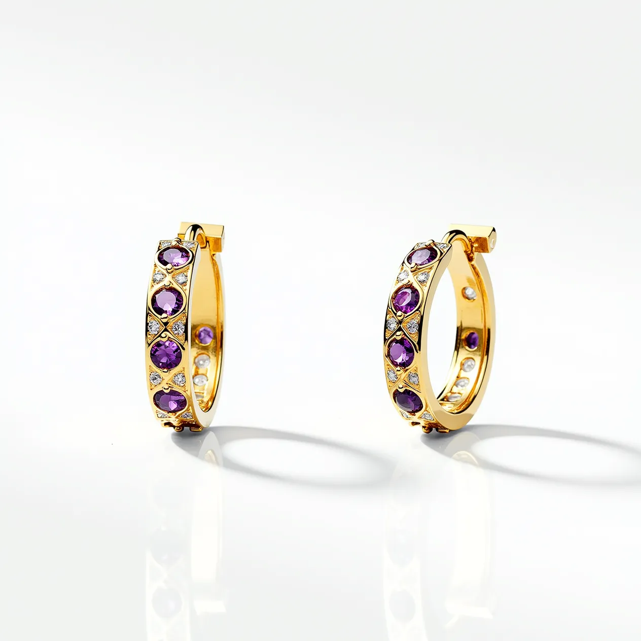 These hoop earrings are crafted from a gold-toned metal, featuring a series of round purple gemstones that are evenly spaced along the outer surface. These gemstones are likely amethysts, given their rich purple hue, and are cut in a round shape to enhance their sparkle. In addition to the purple stones, smaller clear stones are set between them, providing a contrast and additional brilliance. The earrings are designed with a secure hinged clasp, ensuring a snug and comfortable fit when worn. The combination of gold tones and vibrant stones gives these earrings a luxurious and elegant appearance.