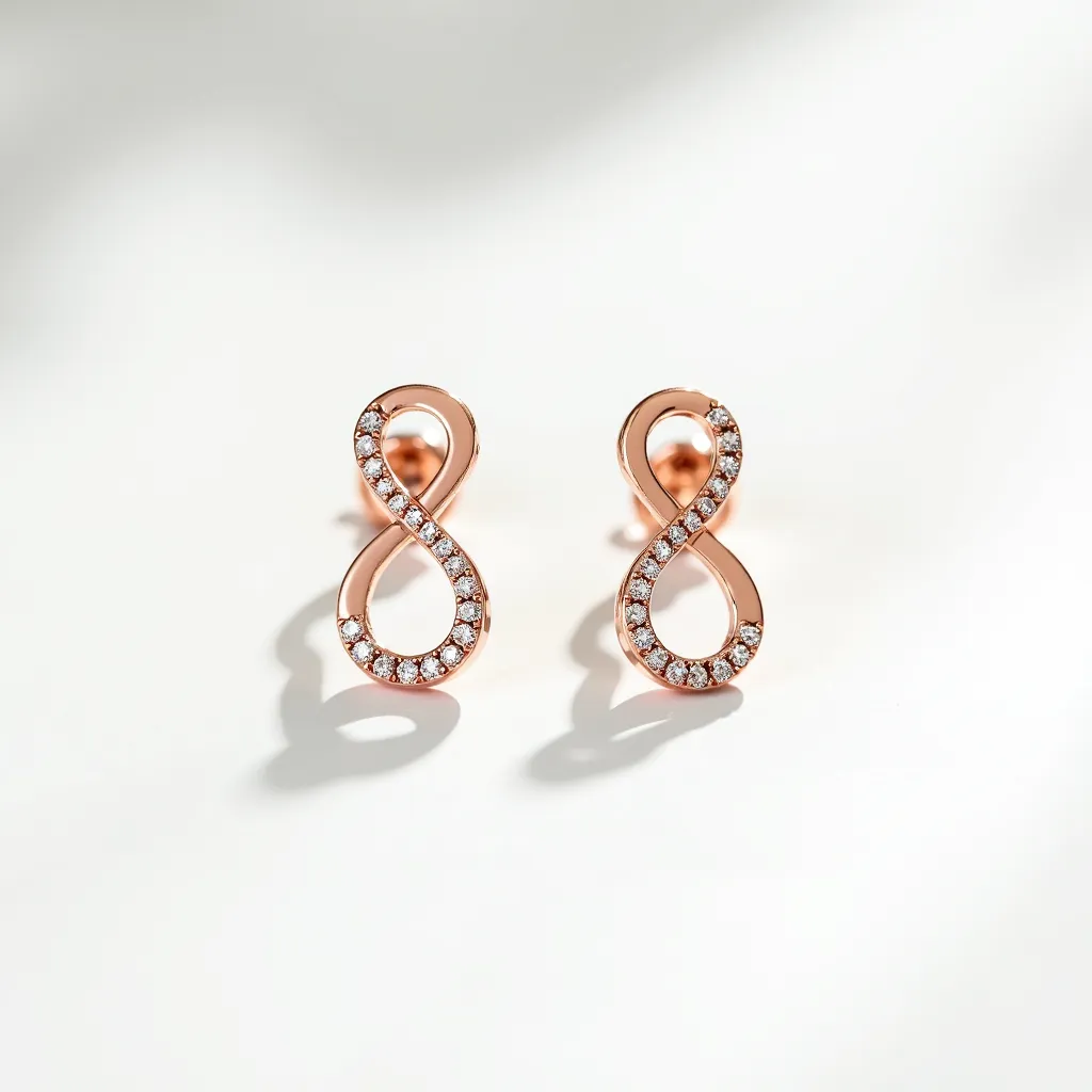 These infinity earrings are crafted from a warm, rose gold metal, showcasing a sleek and elegant design. Embedded along the curves of each infinity loop are small, round-cut gems, likely diamonds or cubic zirconia, that add a touch of sparkle and sophistication. The stones are tightly set, indicating a pavé setting, which enhances their shimmer and the elegant appearance of the earrings. These earrings are secured with a post and clutch back attachment, offering both simplicity and security for everyday wear.