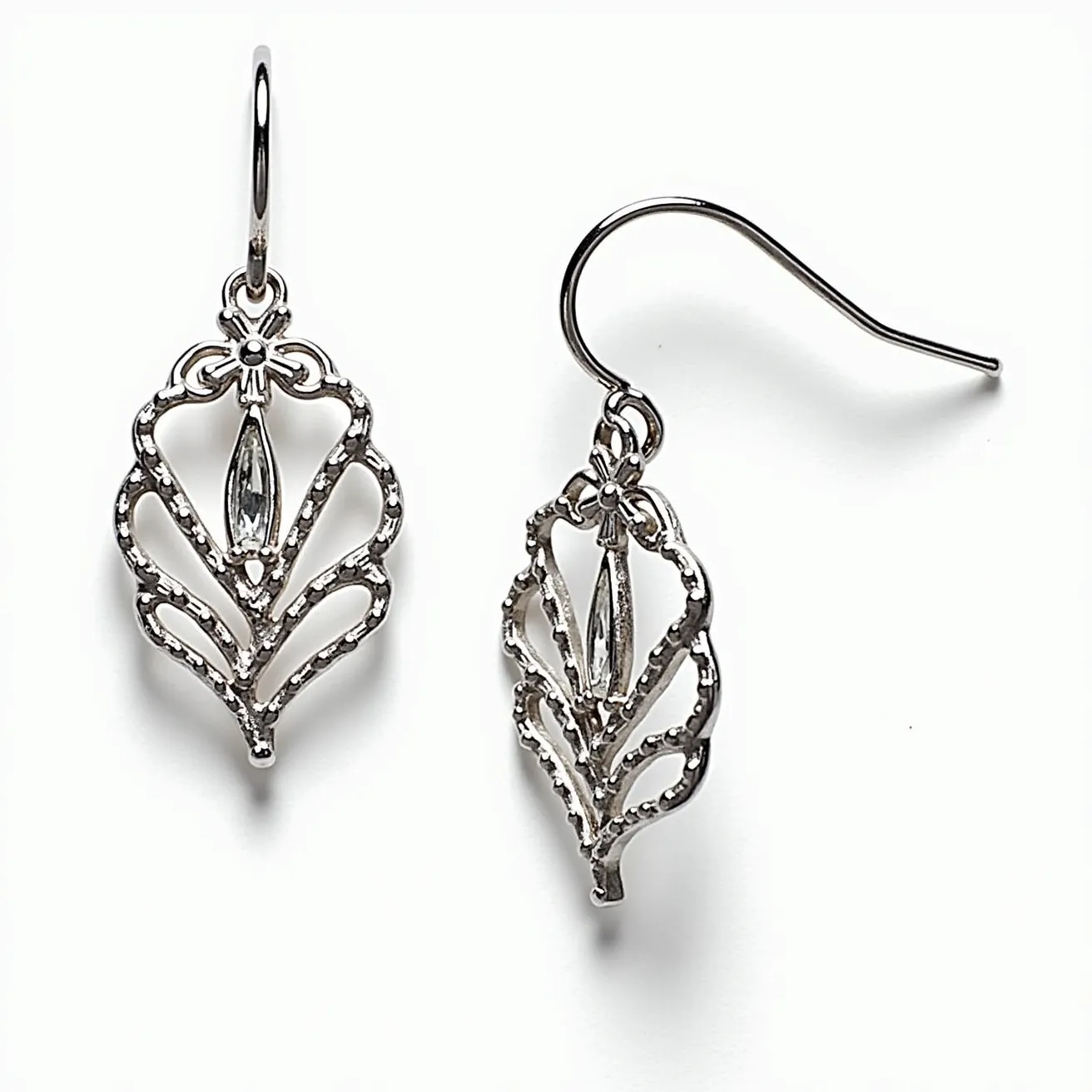 These leaf earrings feature an intricate design crafted from a silver-toned metal. The centerpiece of each earring is a marquise-cut clear gemstone, elegantly set in a simple prong setting that allows light to pass through, enhancing its brilliance. The leaf design is articulated in a filigree style, adding an airy and delicate touch to the piece. These earrings are equipped with fish hook clasps, providing an easy and secure attachment method. The overall effect of the design is both sophisticated and timeless, capturing the essence of natural beauty with a modern twist.